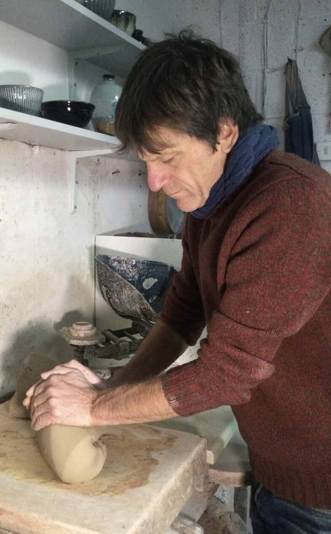 Matt Waite in his studio wedging clay.png