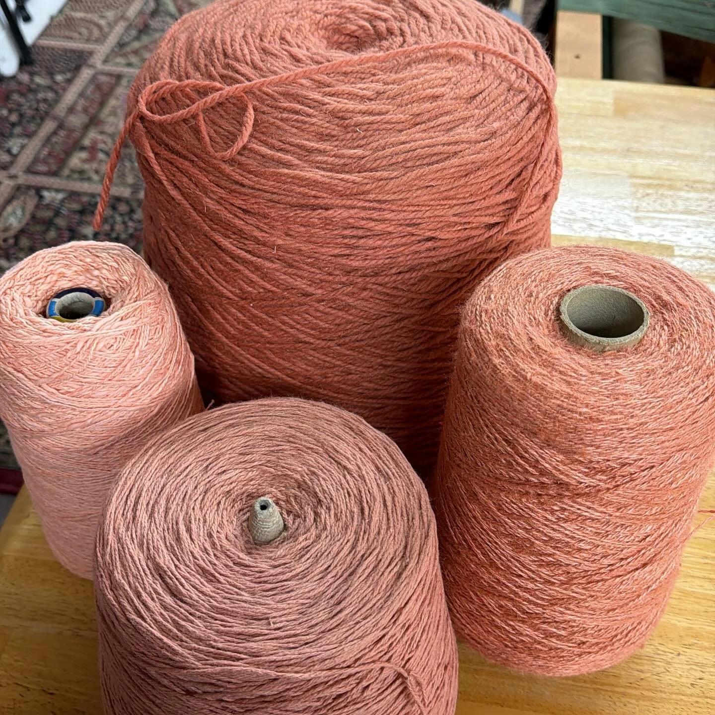 Went through many of my yarns yesterday, organizing and seeing what I have. I found these four cones of the same color but different content; linen, wool, cotton and cotton flake. My eye is drawn to this color it seems.  What color(s) would you put w
