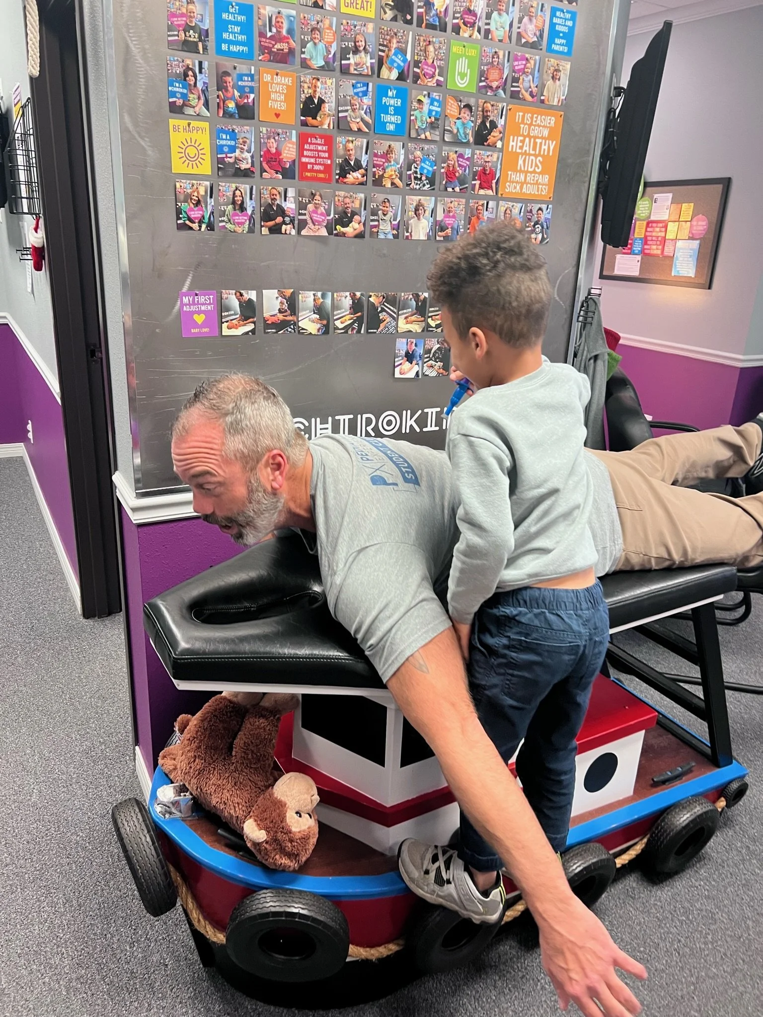 Young boy pretending to adjust Dr. Drake