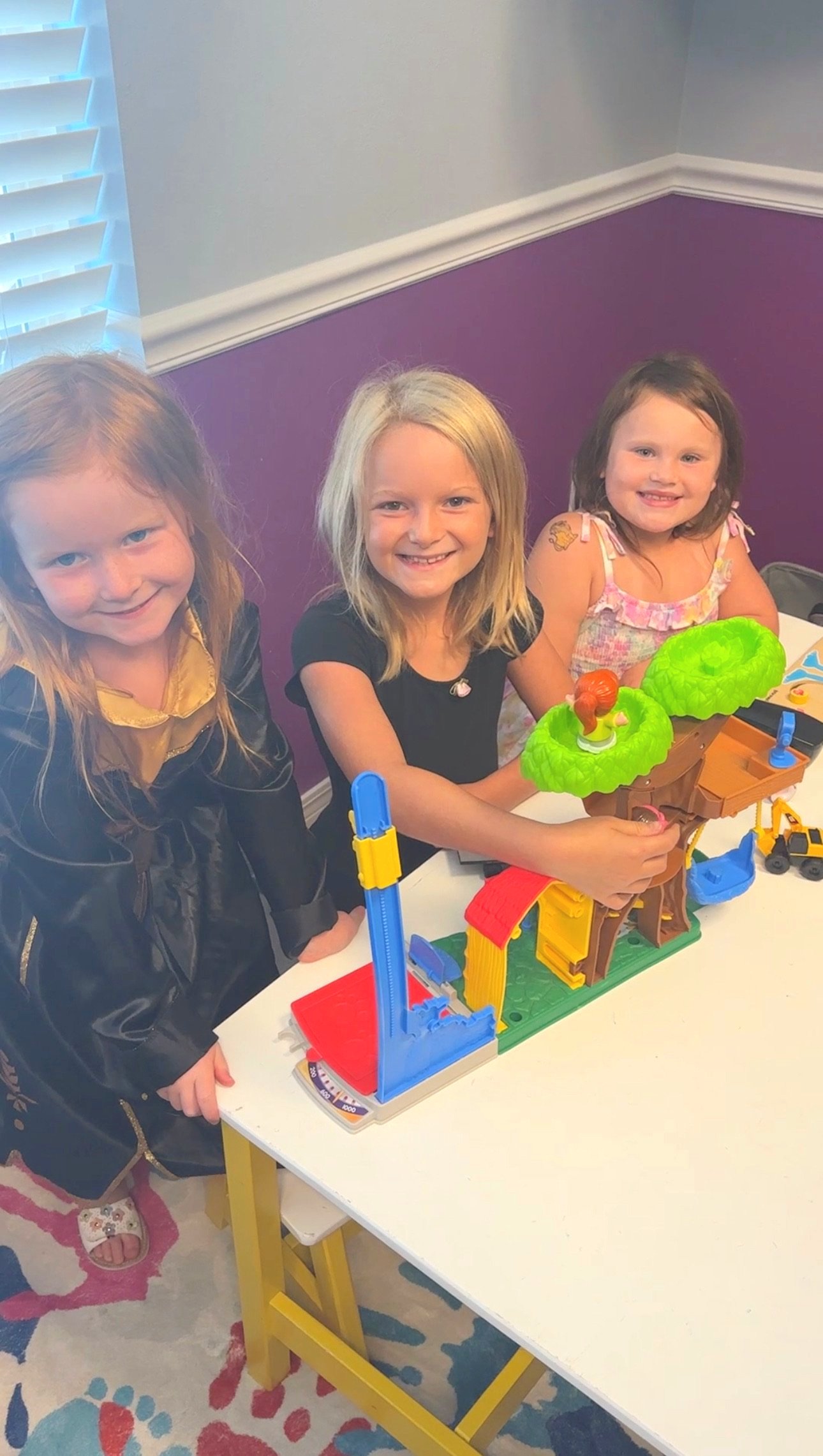 Three girls playing in kid area