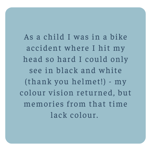 Light blue background with centered text recounting a childhood bike accident that caused temporary black and white color vision.