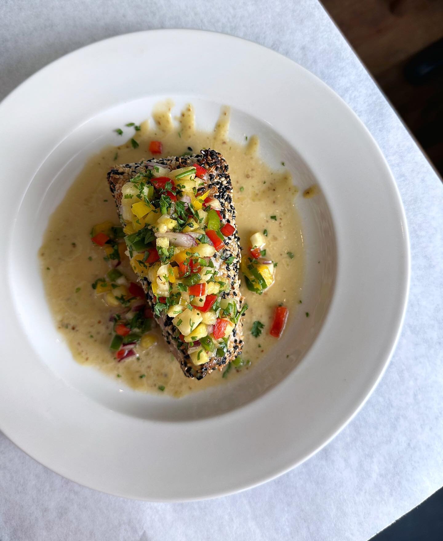This beautiful dish featured tonight is our sesame crusted Yellowfin Tuna with wasabi sauce and pineapple salsa! Cheers!
