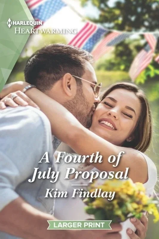 Cover Art for Kim Findlay's romance novel "A Fourth of July Proposal."   A young couple in a gentle embrace are outdoors on a sunny summer afternoon.  He holds a bouquet of beautiful yellow flowers.  Blurred behind are american flag banners ina park