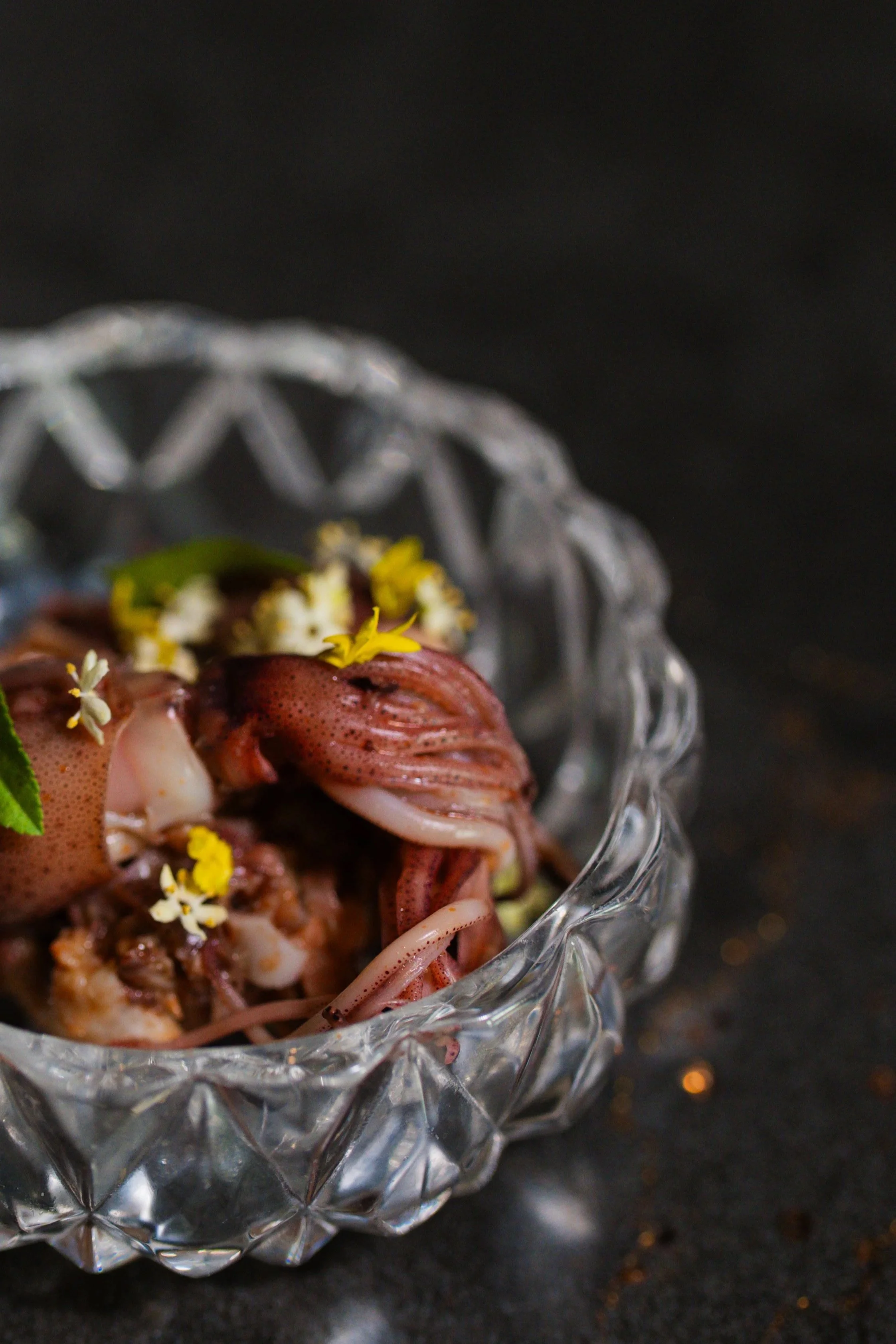 Japanese squid embellished with flowers in a carved glass dish