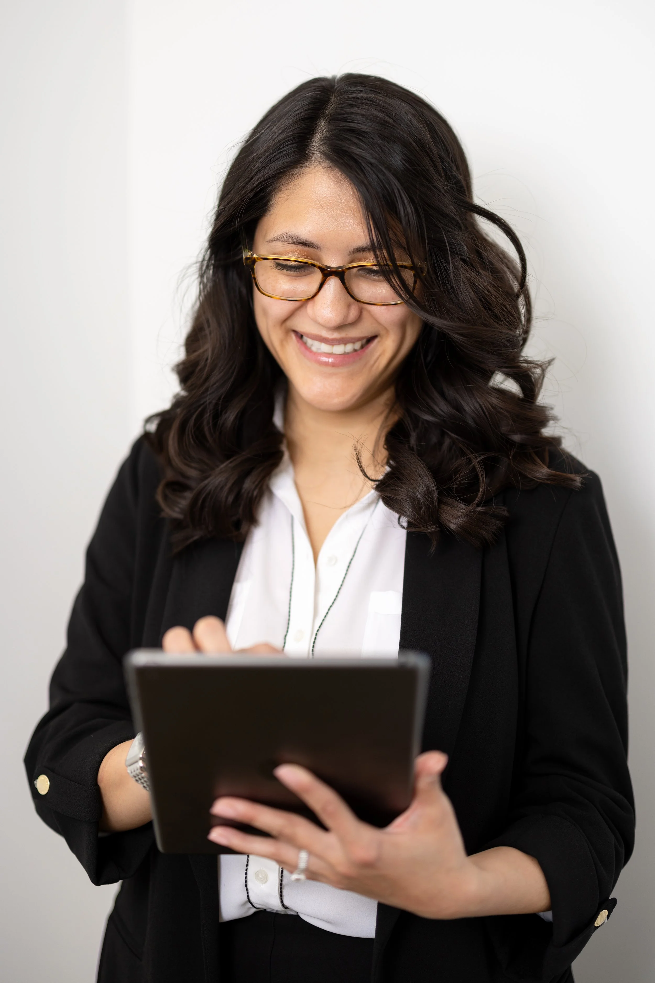 Amy Zembriski, woman with long dark hair and glasses, smiling.