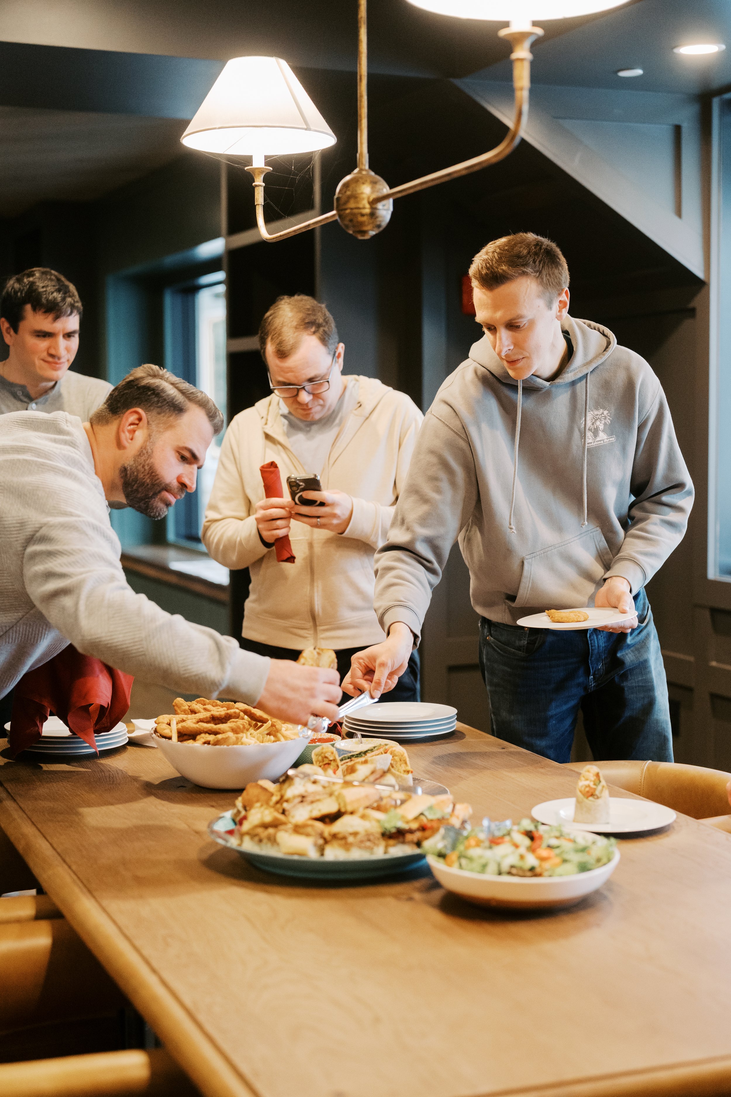 Groomsmen eating lunch in the speakeasy lounge.