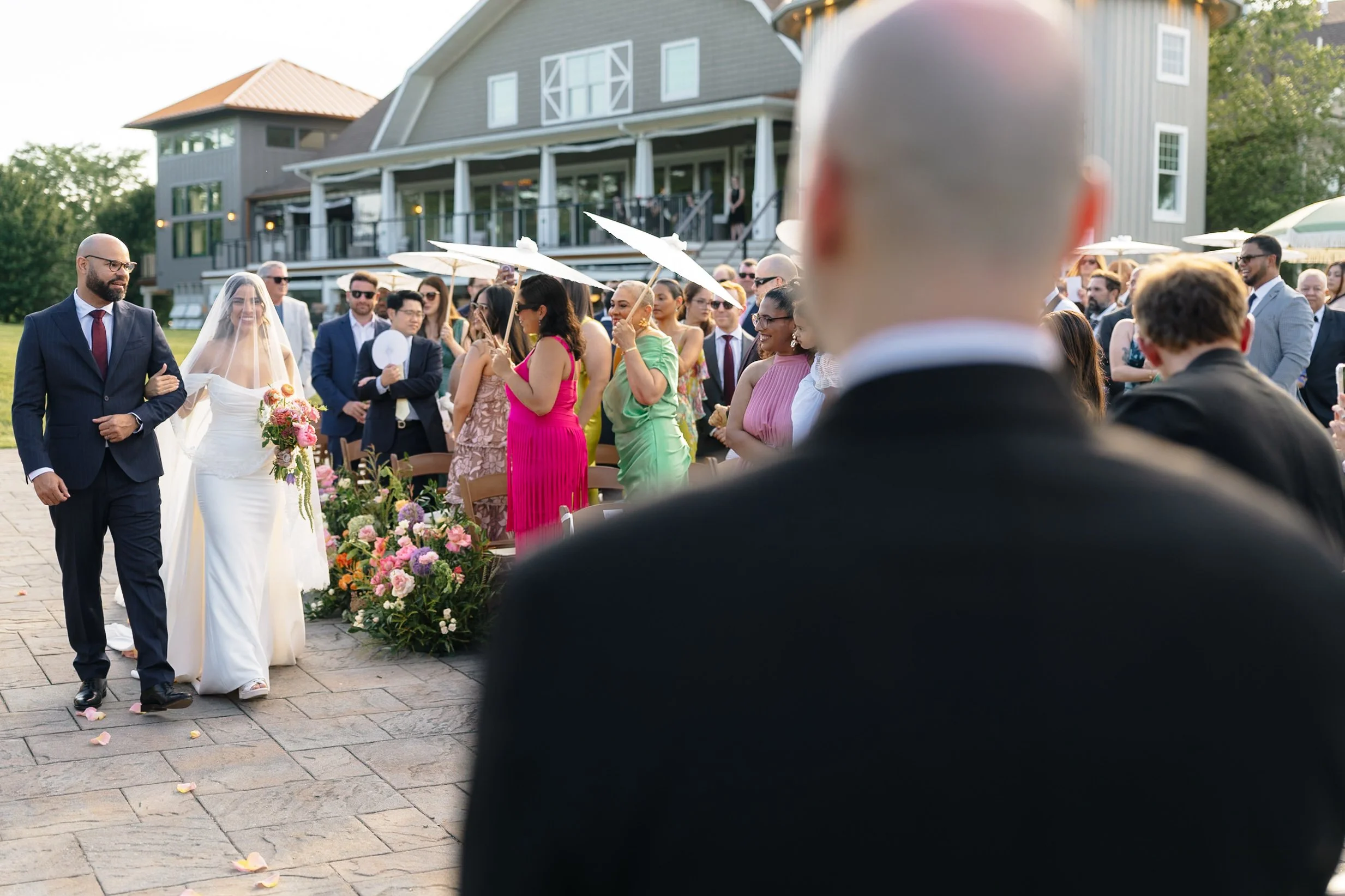 walking down aisle, pond ceremony, umbrellas, summer.jpg