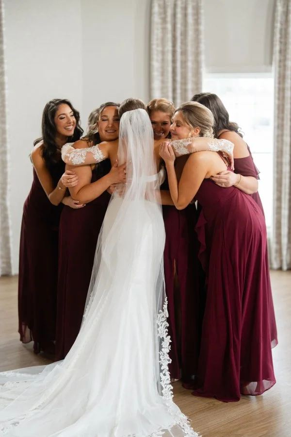 bridal party bridal suite hug bride winter.jpg