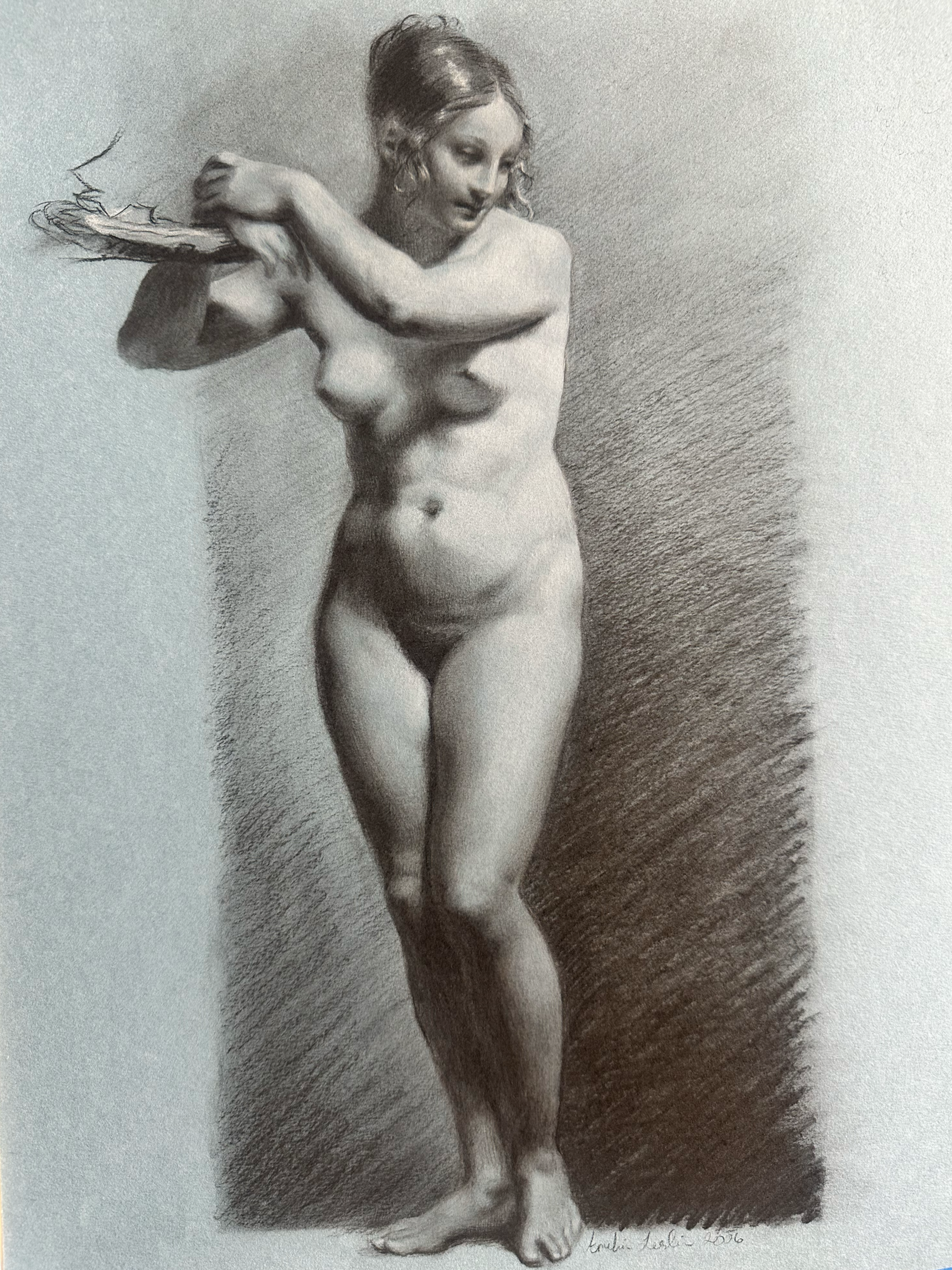 A realistic charcoal drawing of a nude woman with curly hair, standing with her eyes closed and arms crossed over her chest. The background is shaded on one side, creating depth and contrast. It is a master copy after Pierre-August Pru don