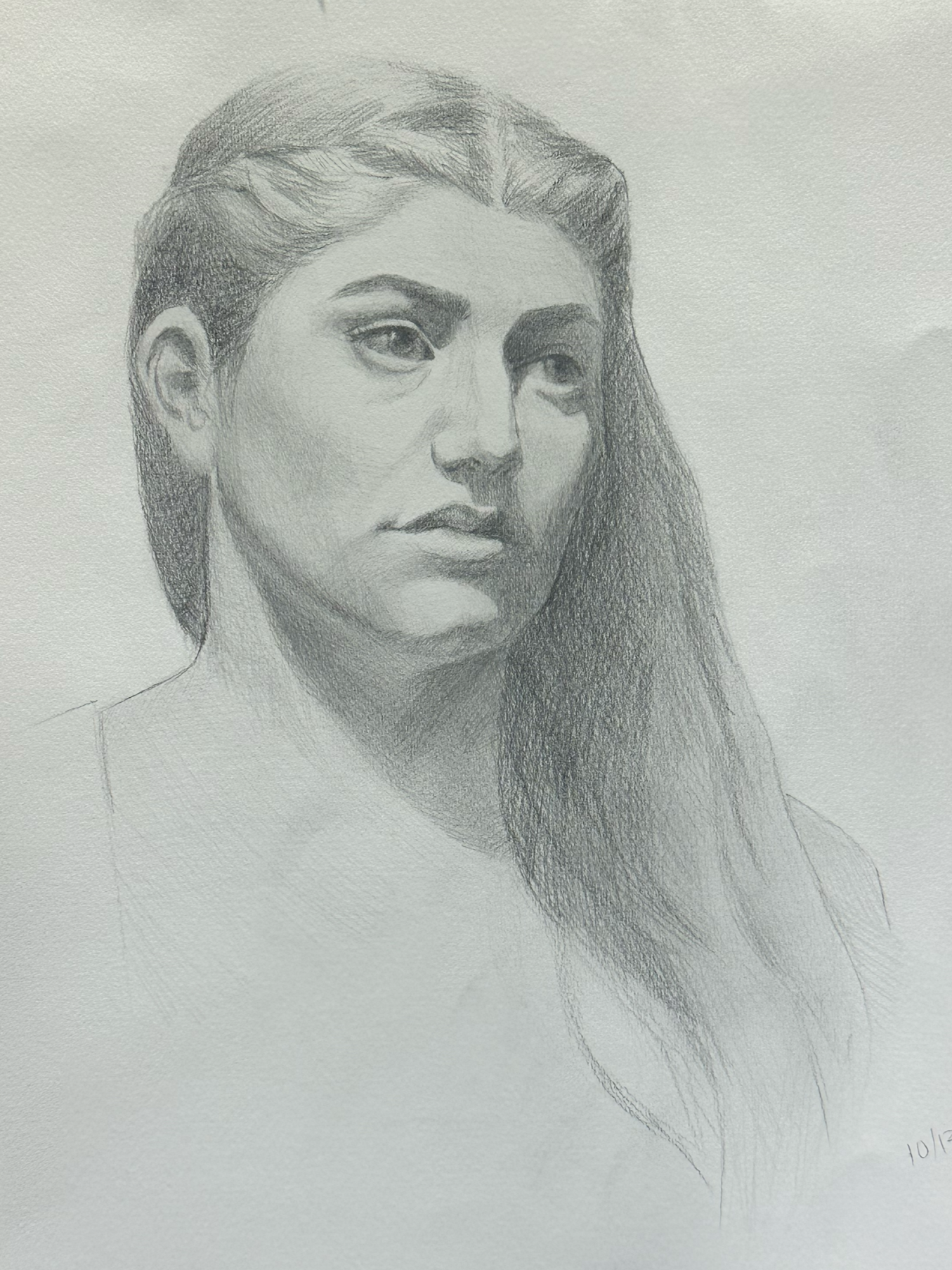 A detailed pencil drawing of a woman with long hair, gazing to her left, with a neutral expression on her face.