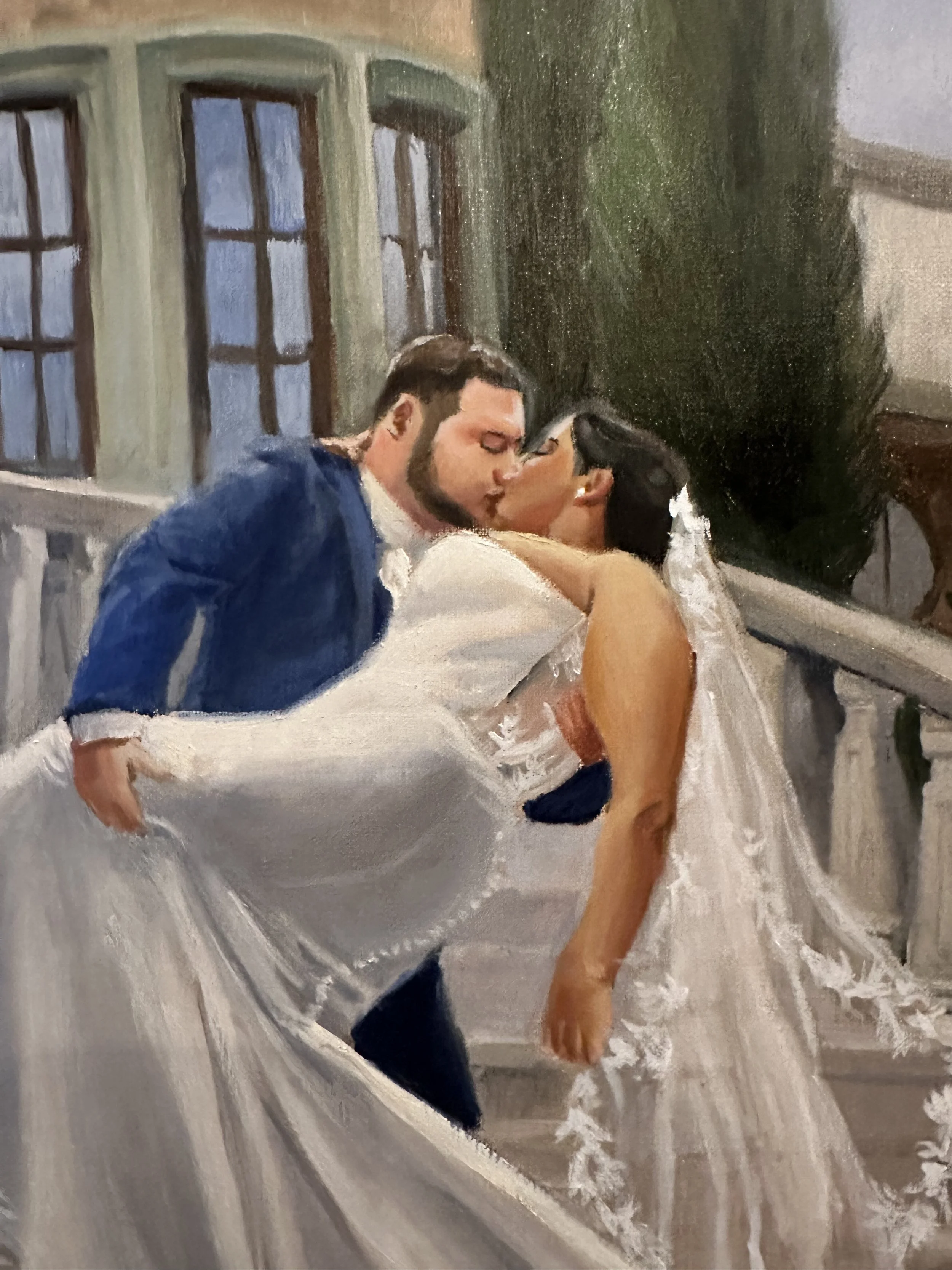 This is an upclose detail shot of a wedding painting featuring a couple kissing on a Tuscan style staircase.