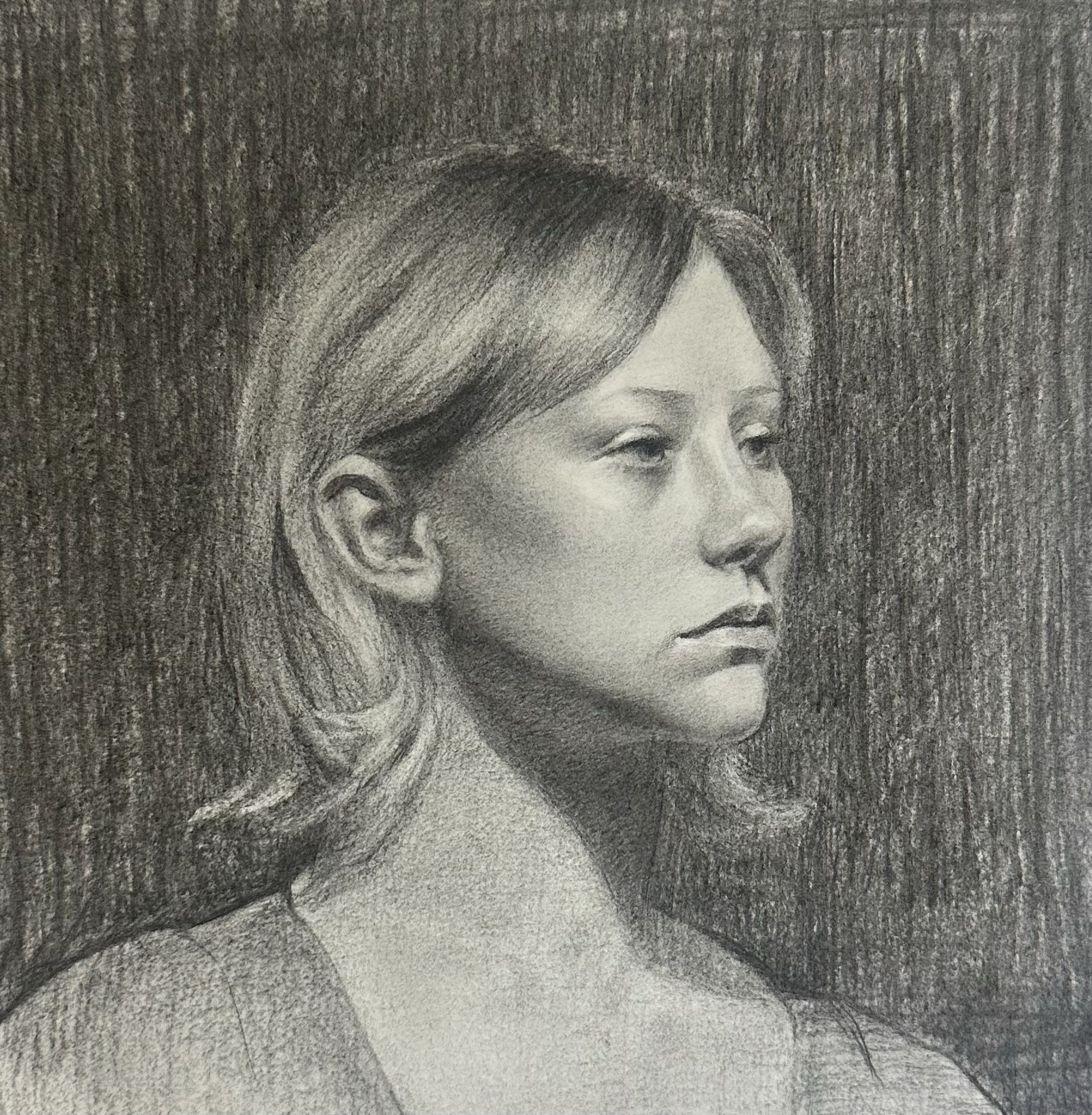 A detailed black and white charcoal sketch of a woman in profile with short, flowing hair, against a textured background.