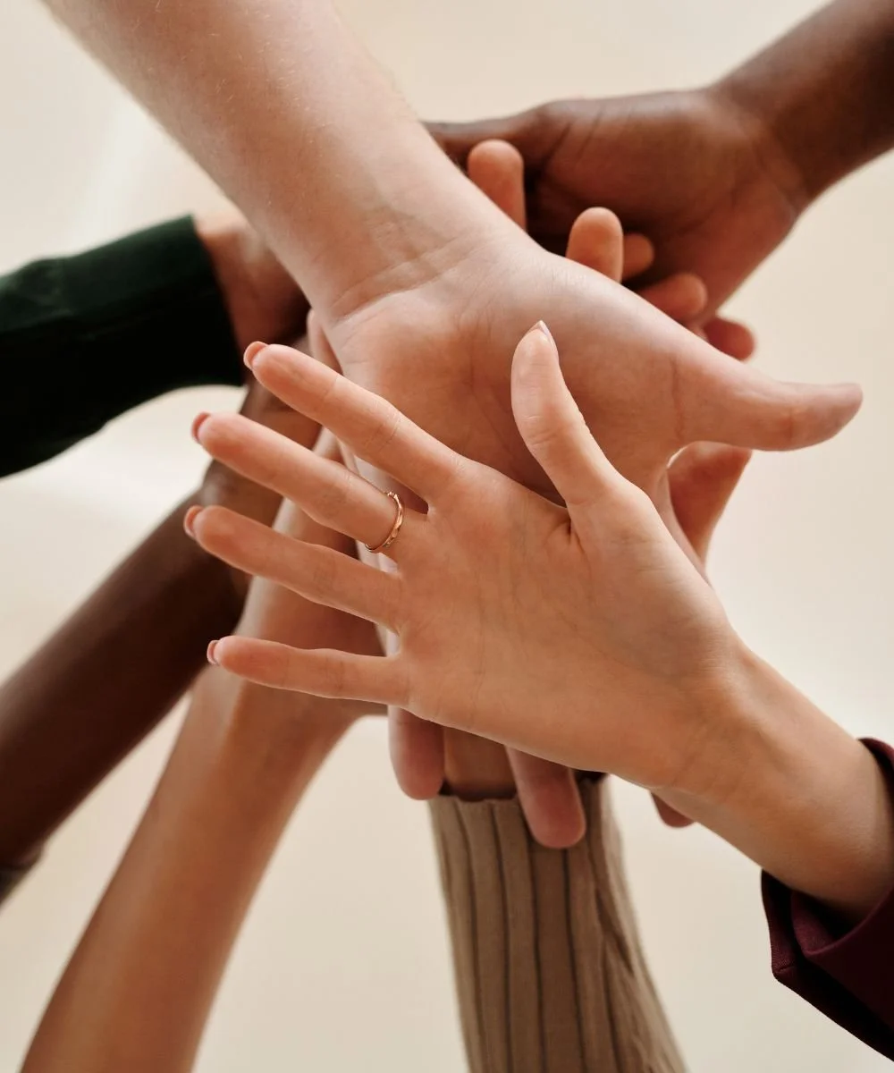 group of women's hands stacked together