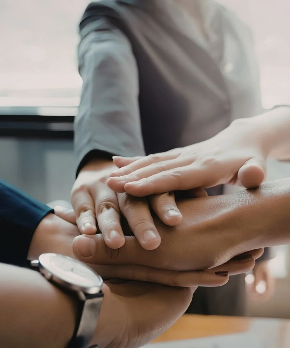 Group of women's hands put together in collaboration