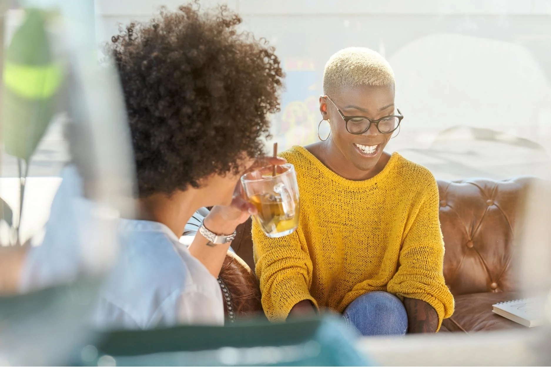 Two women conversing at a cafe together