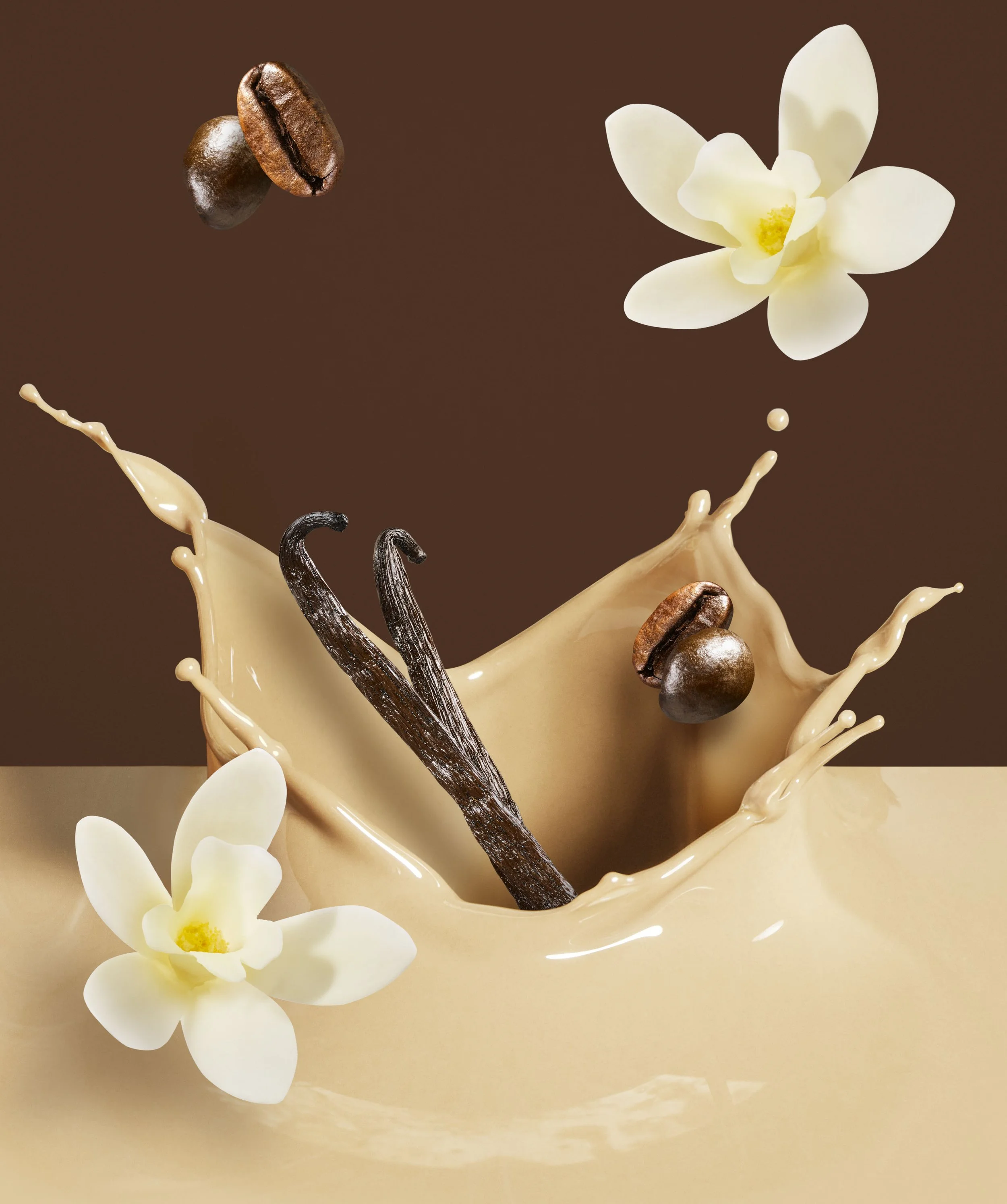 Coffee beans falling into a splash of cream with white flowers in the background.