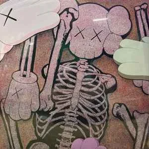 Drawing of a skeleton with cartoonish features holding a large spoon, with various other playful elements around it.