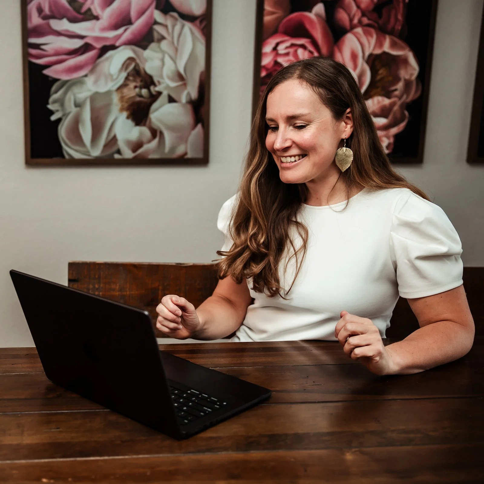 Karina Wenker, Nutritionist, sitting in front of her laptop, speaking to a prenatal client