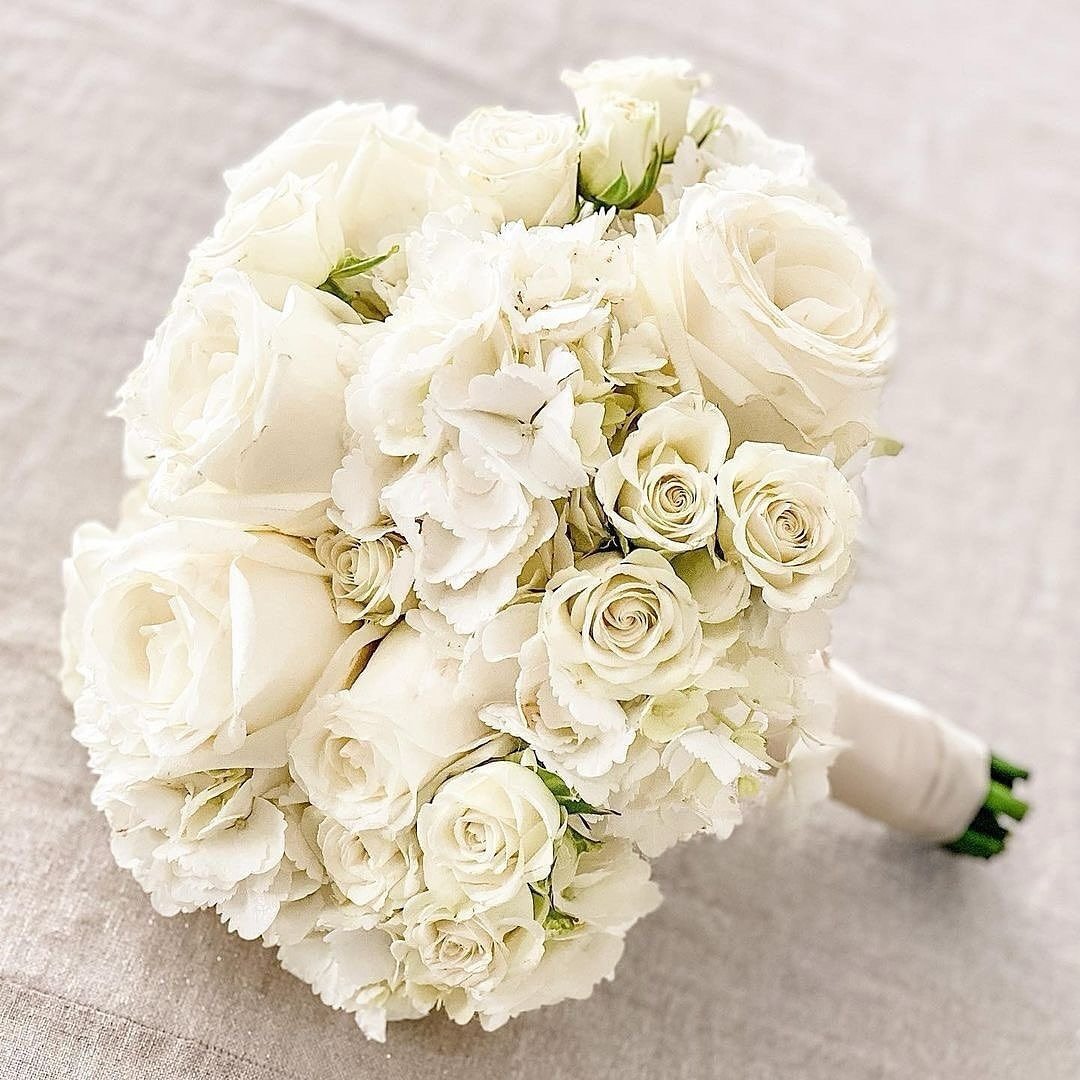 Our Classic White Bridal Bouquet&hellip;is a classic for a reason.💕

This look is for those seeking a timeless romantic look. Filled with texture from hydrangeas, spray roses and large open roses, this look matches any bridal gown.

Learn more about
