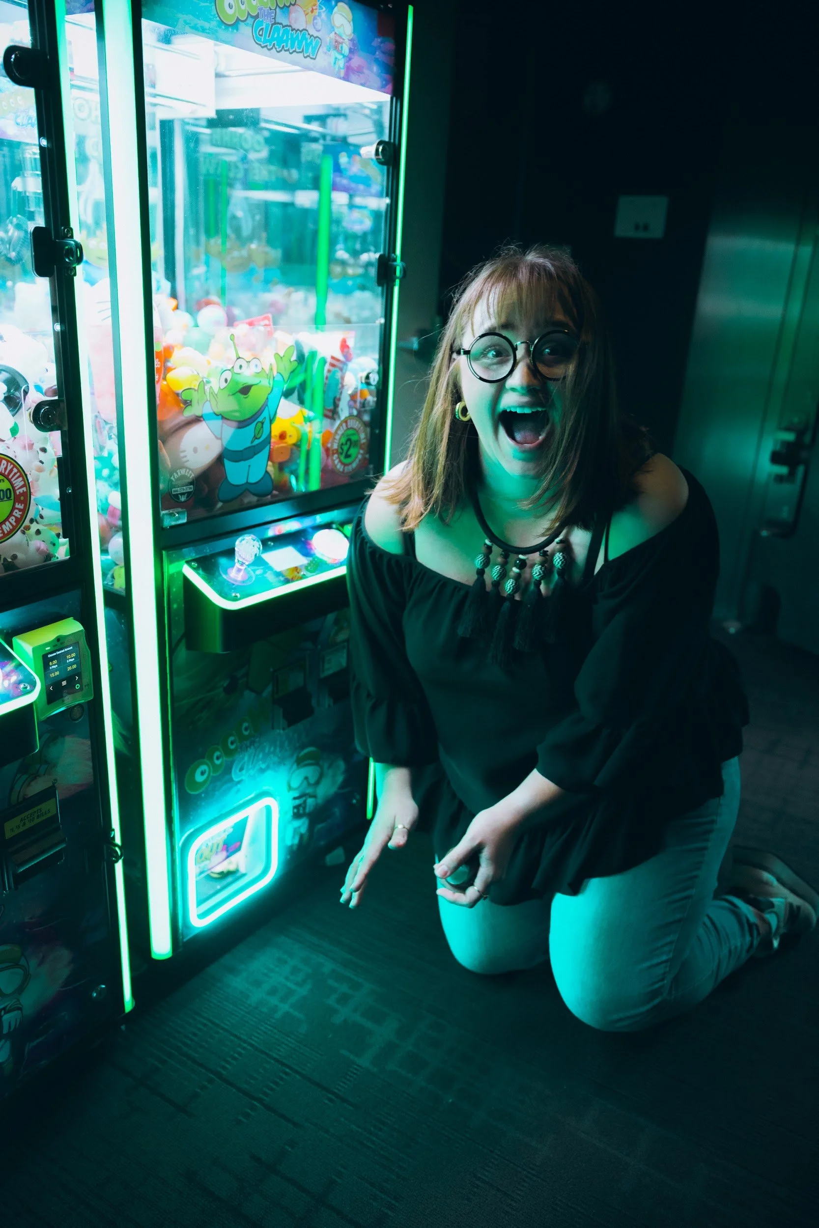 Justine (Margo) winning tiny duck after tiny duck from the claw machine