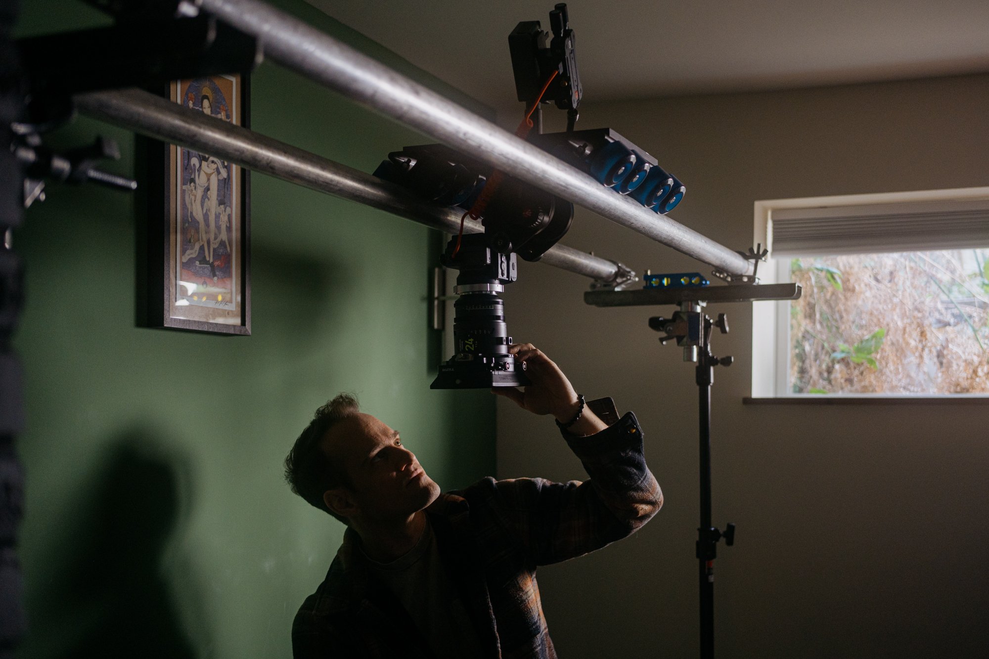 DP Cody Walters adjusts camera before an overhead dolly shot