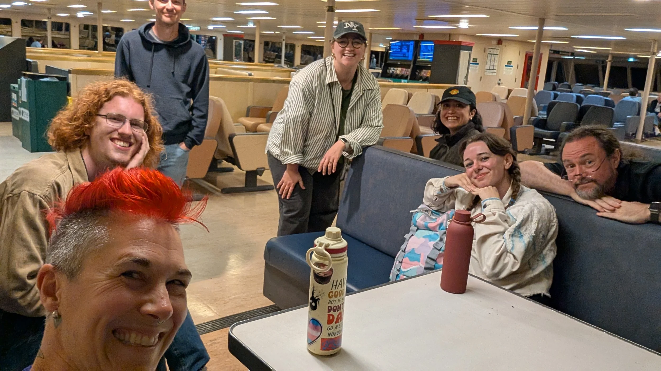 A group of tired cast and crew on the ferry home