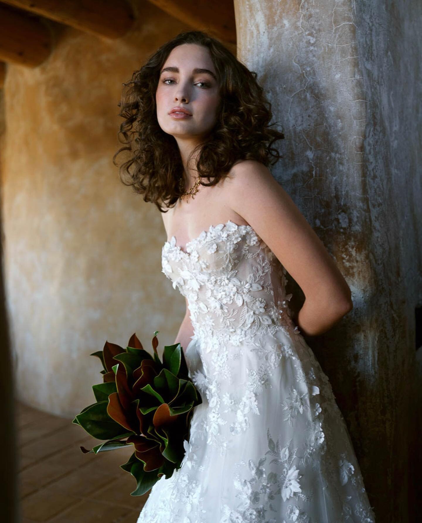 Sweetbrier and wild roses bloom with abandon. 

The Briar is an enchanting romantic gown in a delicate floral French lace over layers of silk organza. Hand embroidered petals, leaves and pearls envelope the fitted bodice and give way to a full skirt 