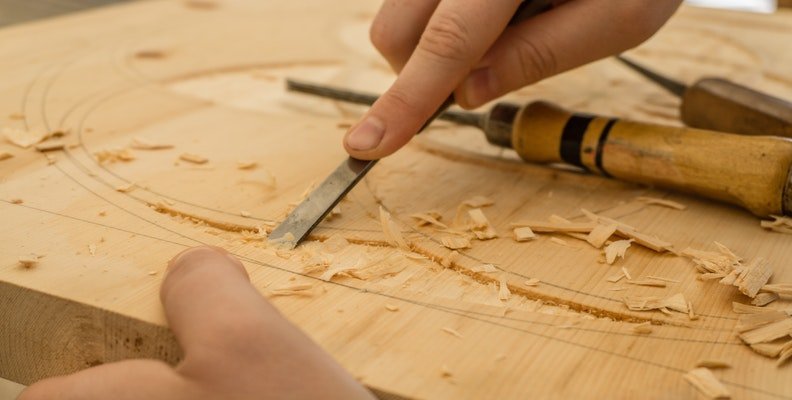  Carving wood. 