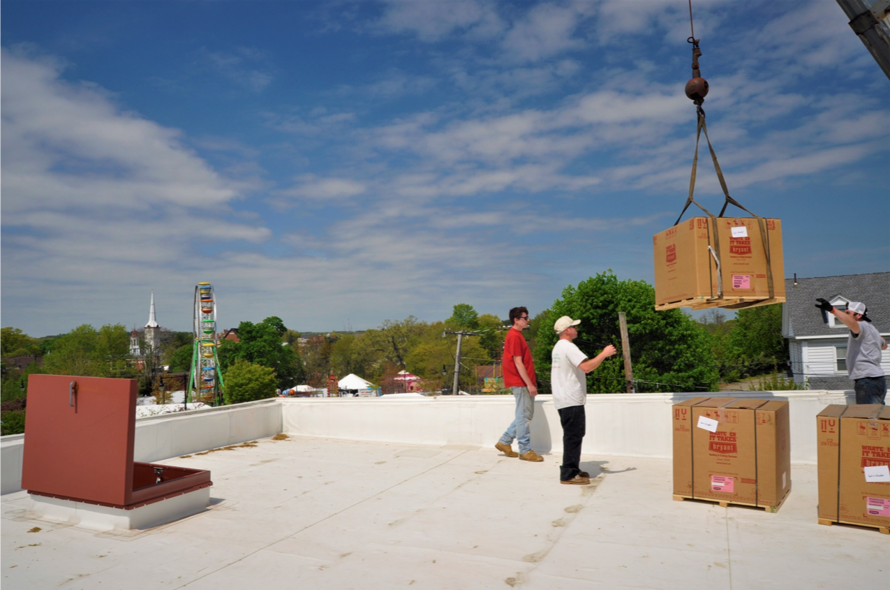  Lifting packages onto the roof. 