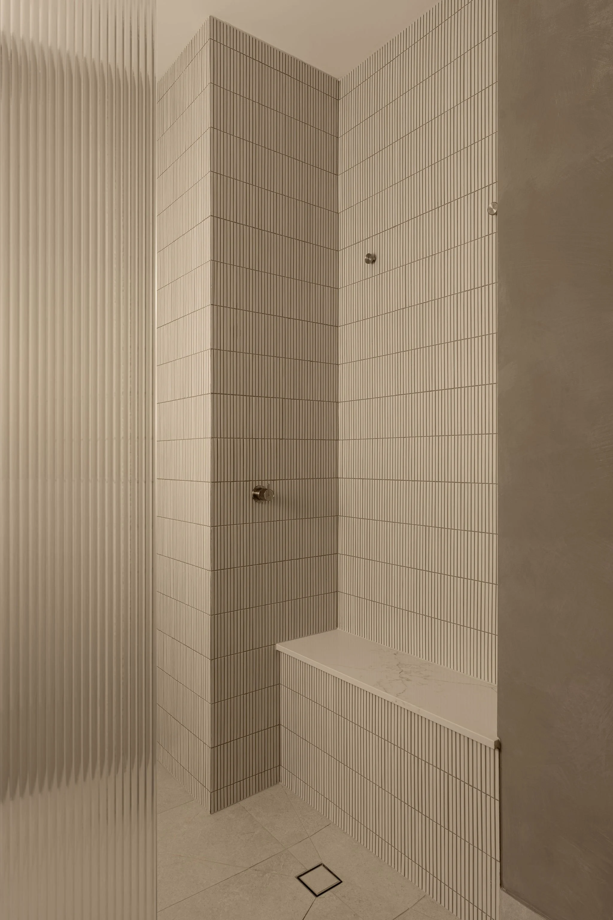 Sunshine Retreat, walk-in shower with cream finger tiles, built-in bench and fluted glass screen