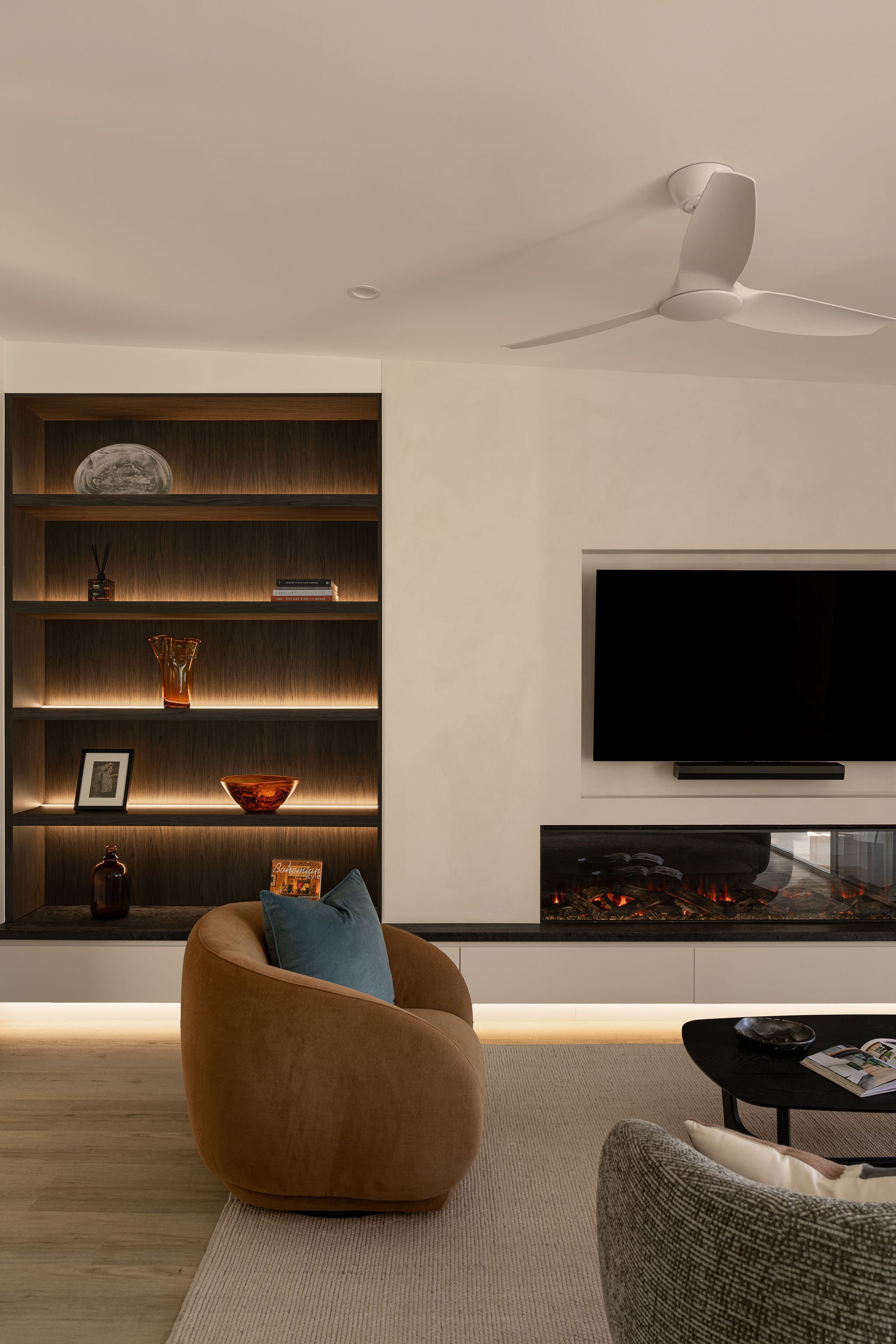 Sunshine Retreat, living room in Sunshine Beach with linear fireplace, wall-mounted TV and lit display shelves