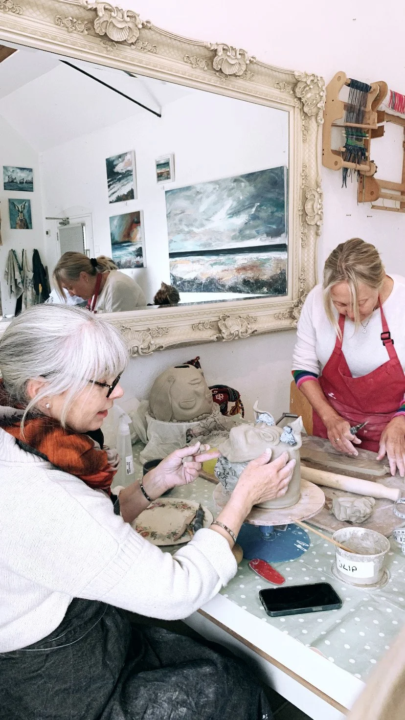 Adults taking part in Isil's pottery workshops in Sway