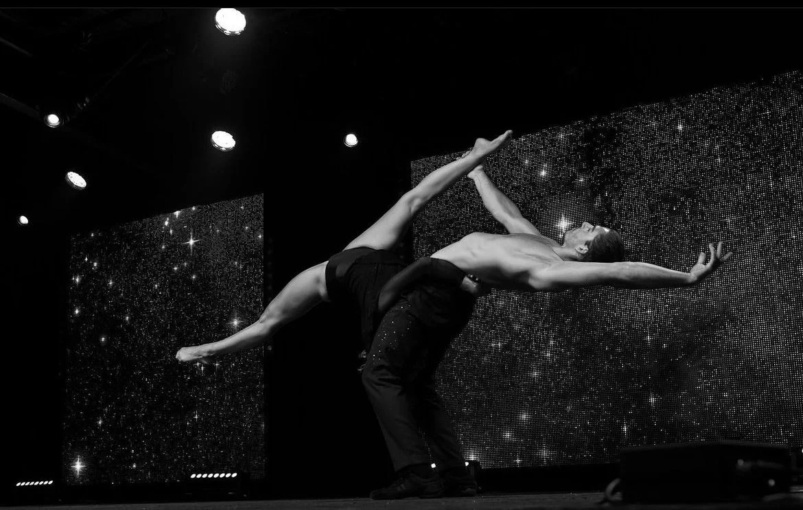 Two figures doing acrobatics