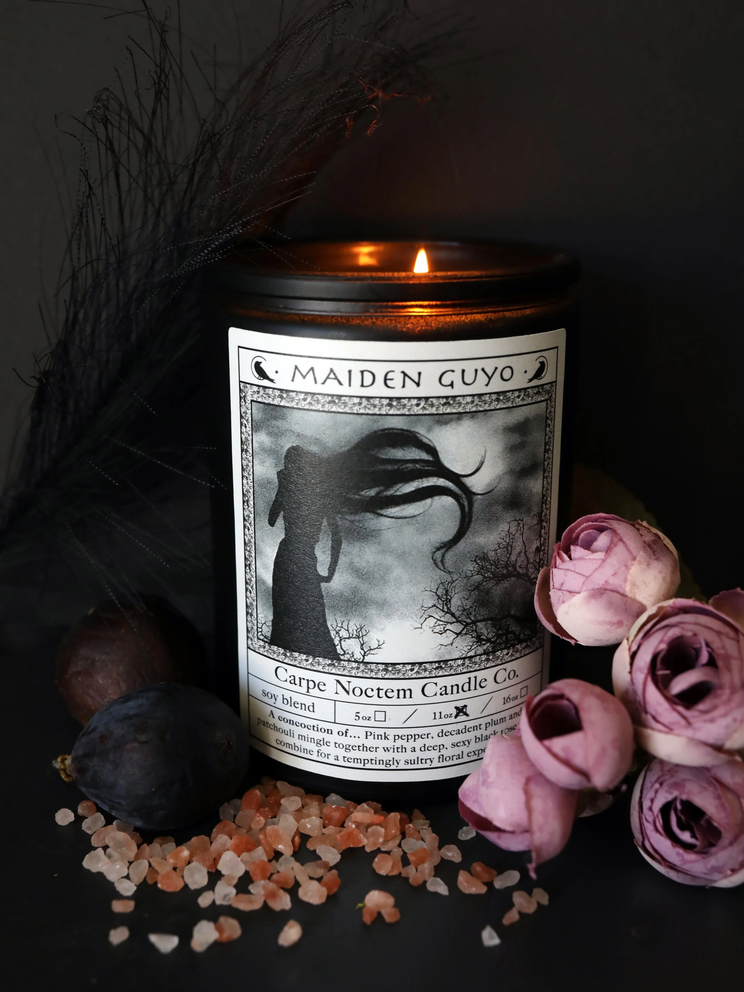 Maiden Guyo Candle burning with rose, pink pepper, plum