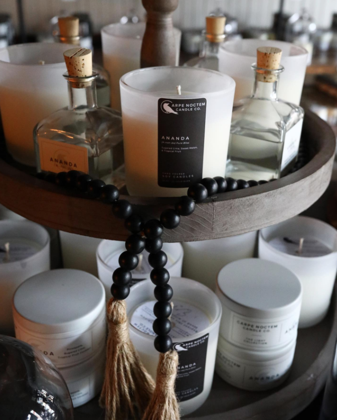 glass vessels of candles arranged for sale at Carpe Noctem Candle Co