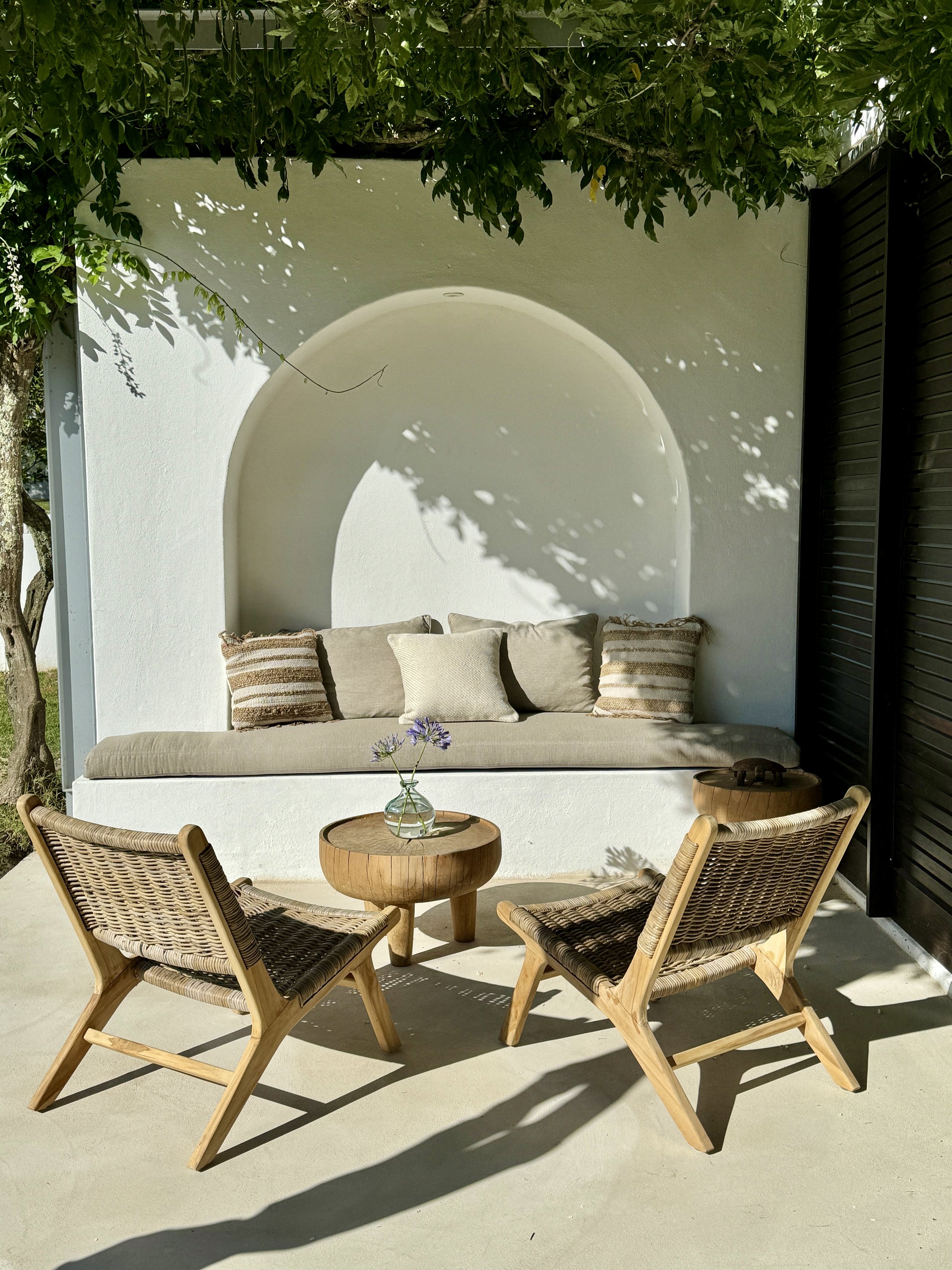 A lounge chair and a wooden table in an outdoor setting at MAISON ESTATE