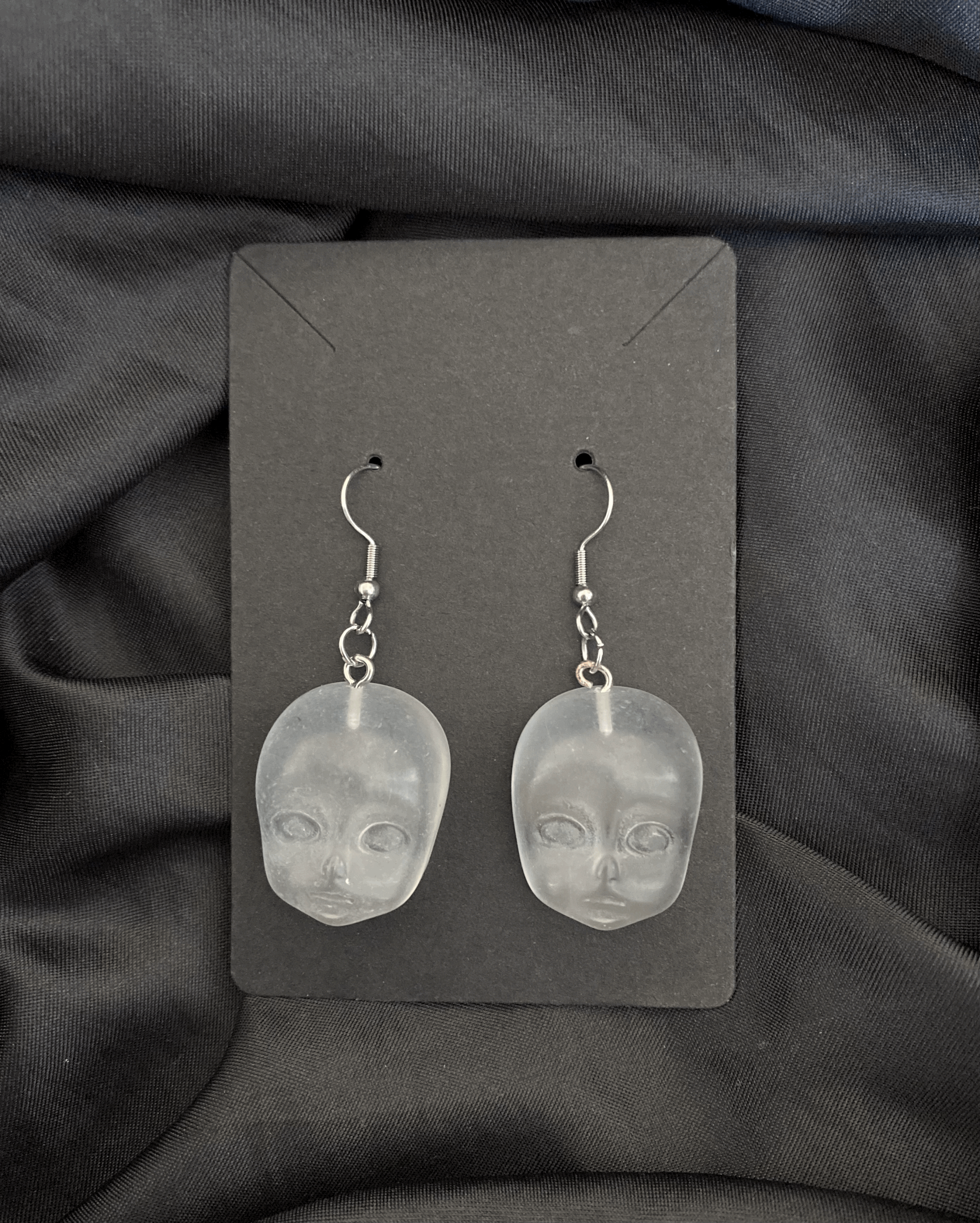 clear doll face earrings