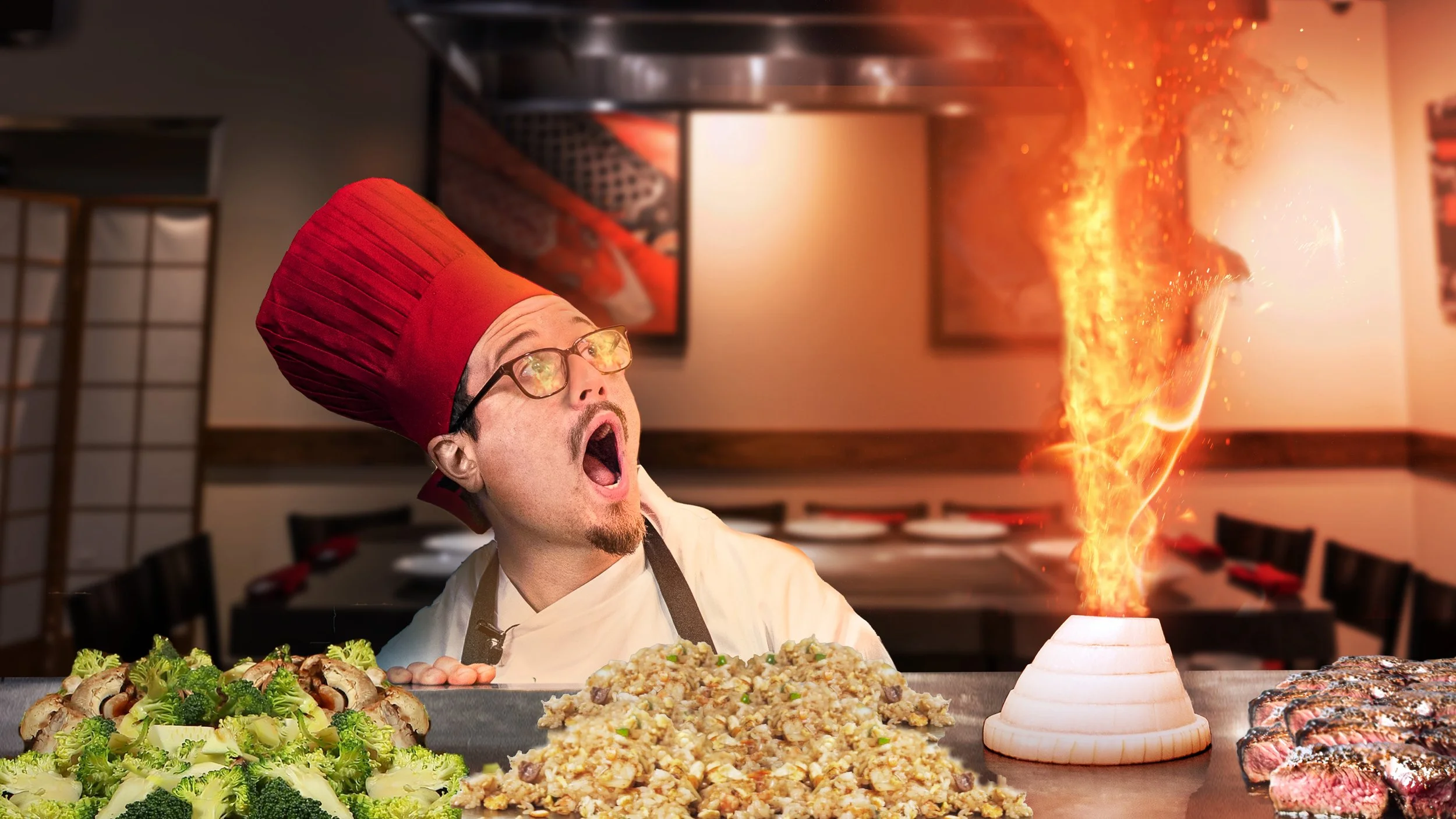 Chef wearing a red toque and glasses has his mouth open as a fiery eruption rises from a volcano-shaped cooking utensil on a restaurant counter, with dishes of broccoli, fried rice, and grilled meat in the foreground.