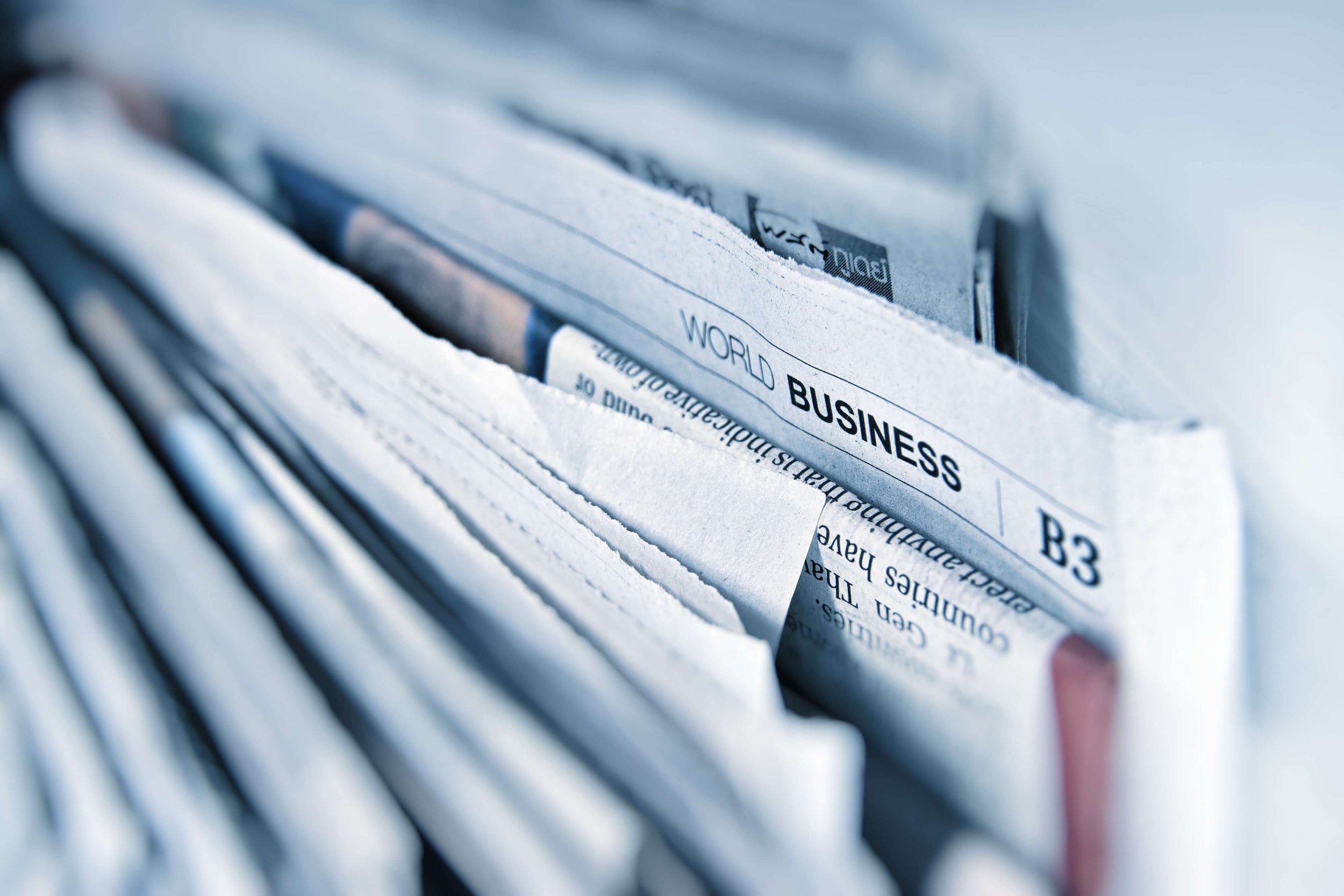 A stack of newspapers with a focus on "world business"