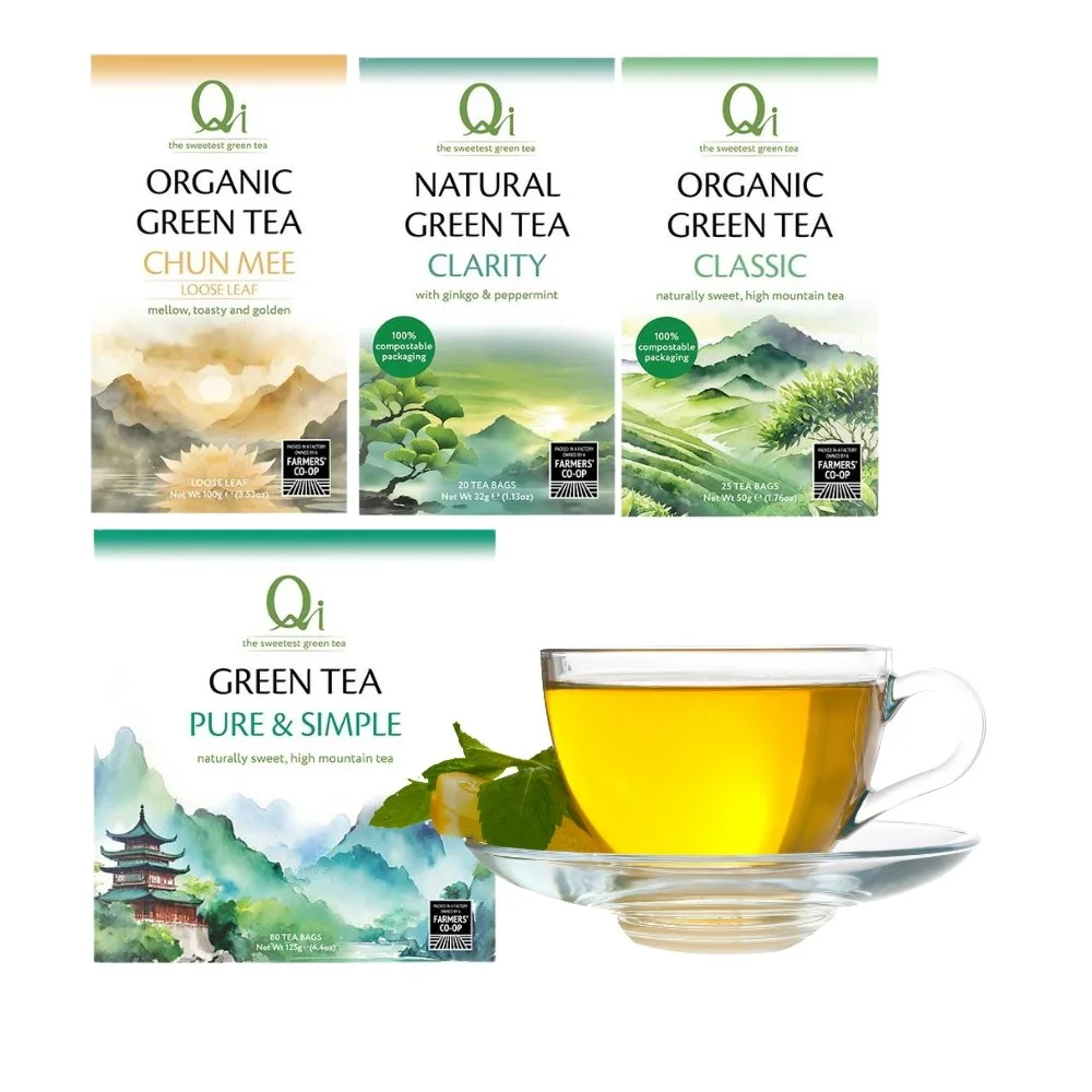 Four boxes of green tea, each labeled with different varieties: organic green tea Chun Mee loose leaf,  Clarity with ginkgo and peppermint, organic green tea , and green tea Pure & Simple. In front of the boxes, there is a glass cup of brewed green tea with a lemon wedge and mint leaves on a clear saucer, against a white background.
