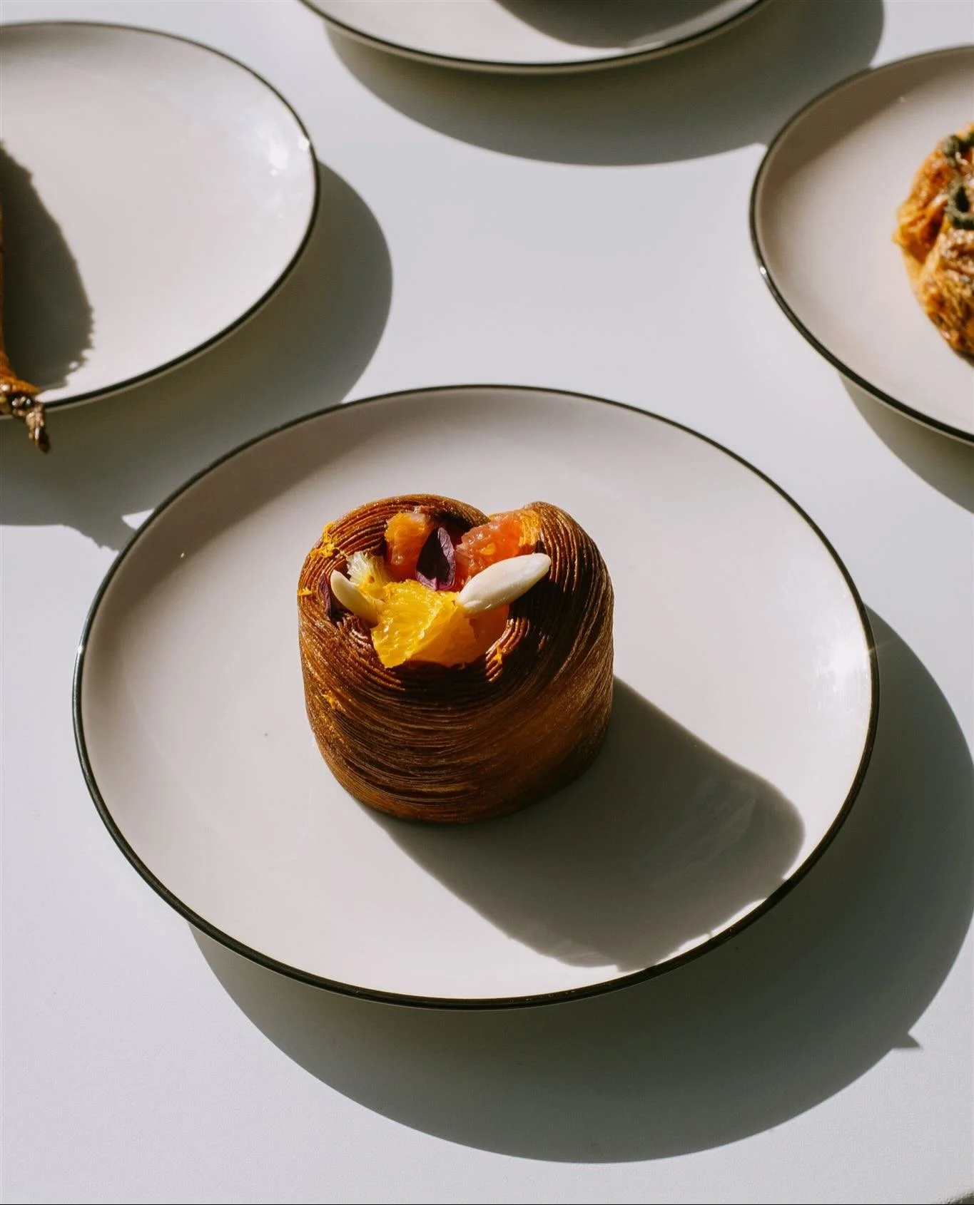 @edan.leshnick&rsquo;s creations for @hudsonwilder Ephemeral Matter pastry series 

Citrus and Marcona Croissant // Croissant dough, Roasted hazelnut sponge, Marcona almond praline, yuzu and mandarin compote topped with fresh seasonal citrus segments