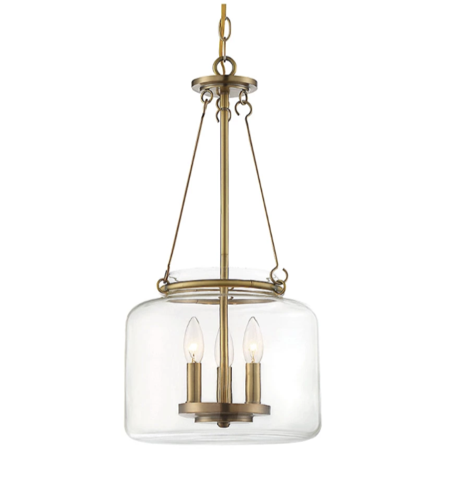 A modern pendant chandelier with a clear glass shade and gold metal accents, featuring three candle-style light bulbs.