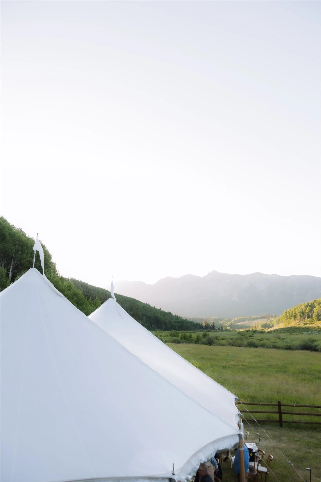 View of a sunset over a tented wedding