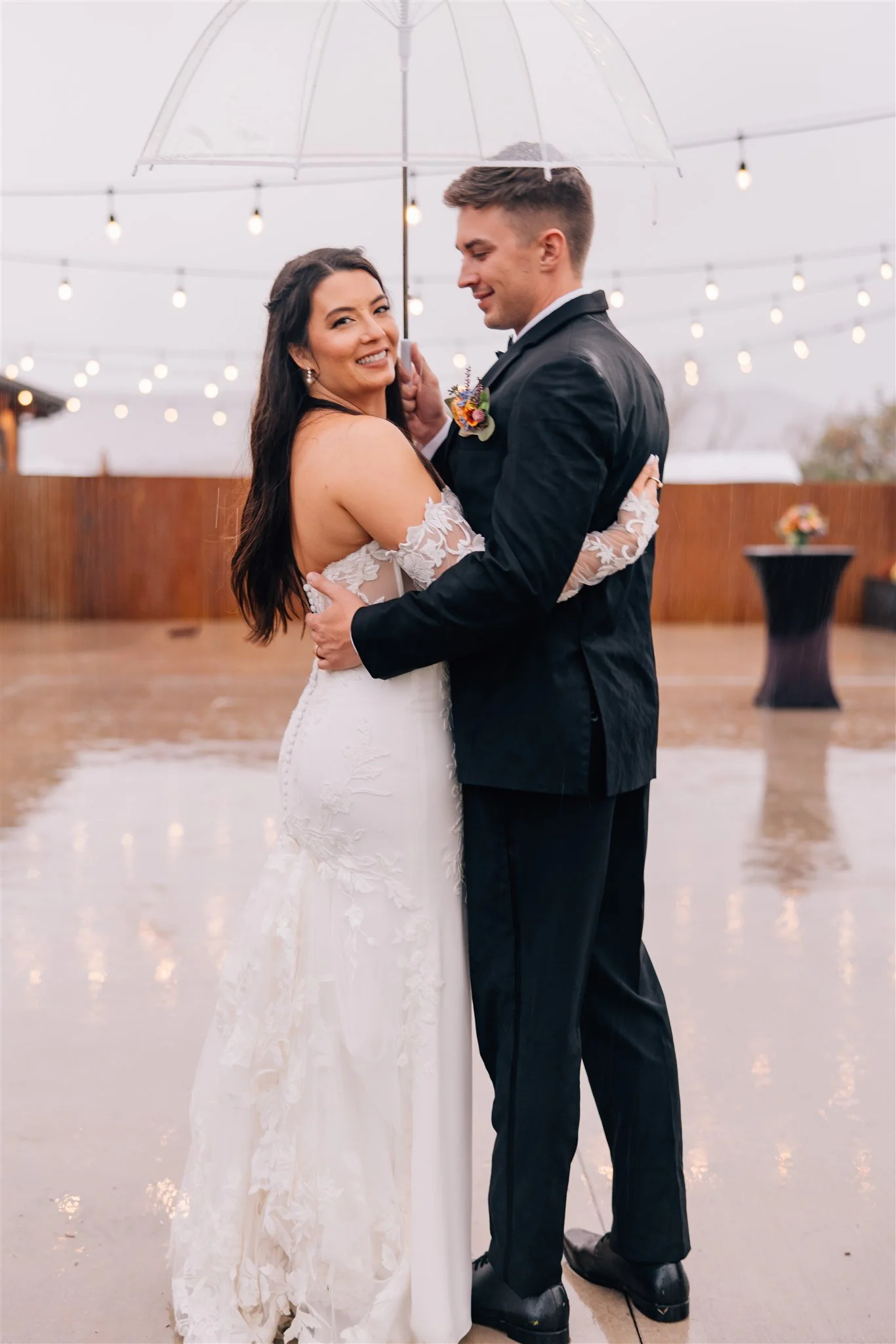Newlyweds smiling in the rain