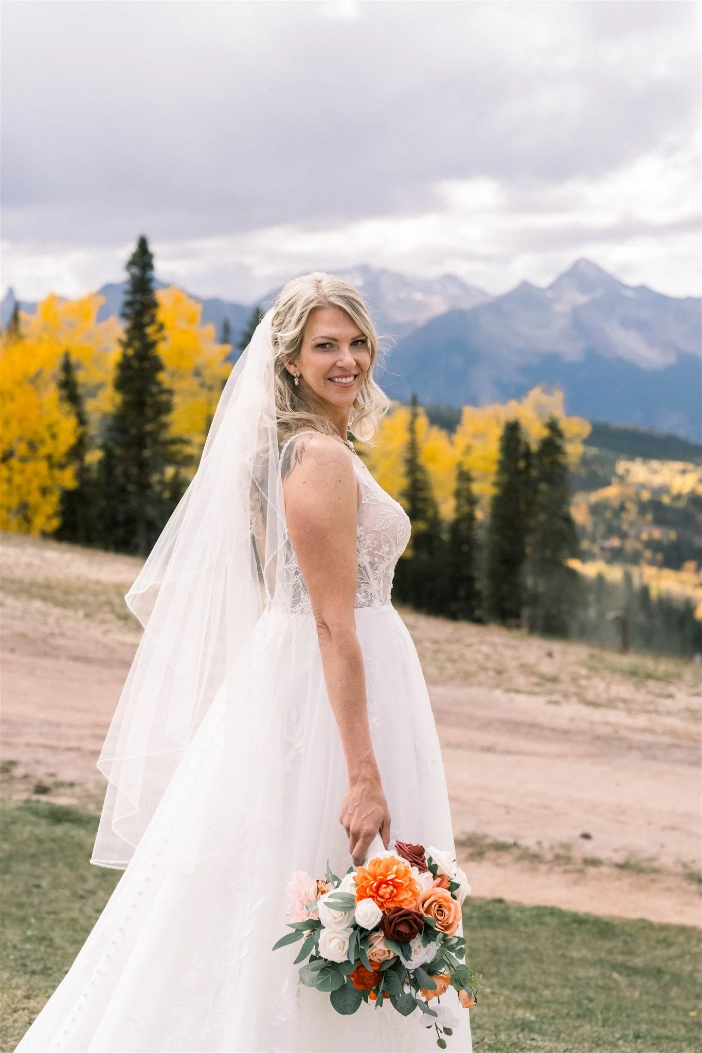 Bride smiles in mountain setting