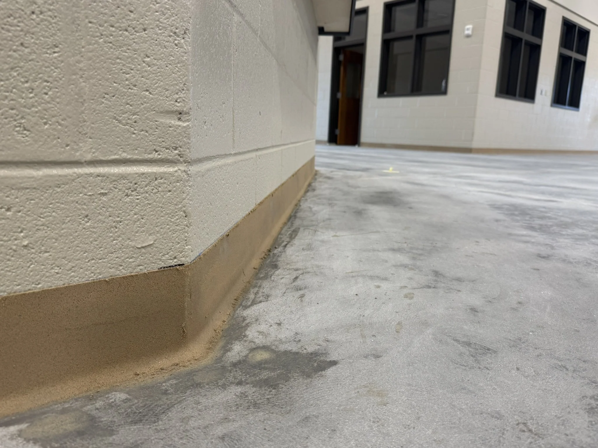 Close-up of epoxy mortar coved base installed in Madison County Ag Center in Danielsville, Georgia