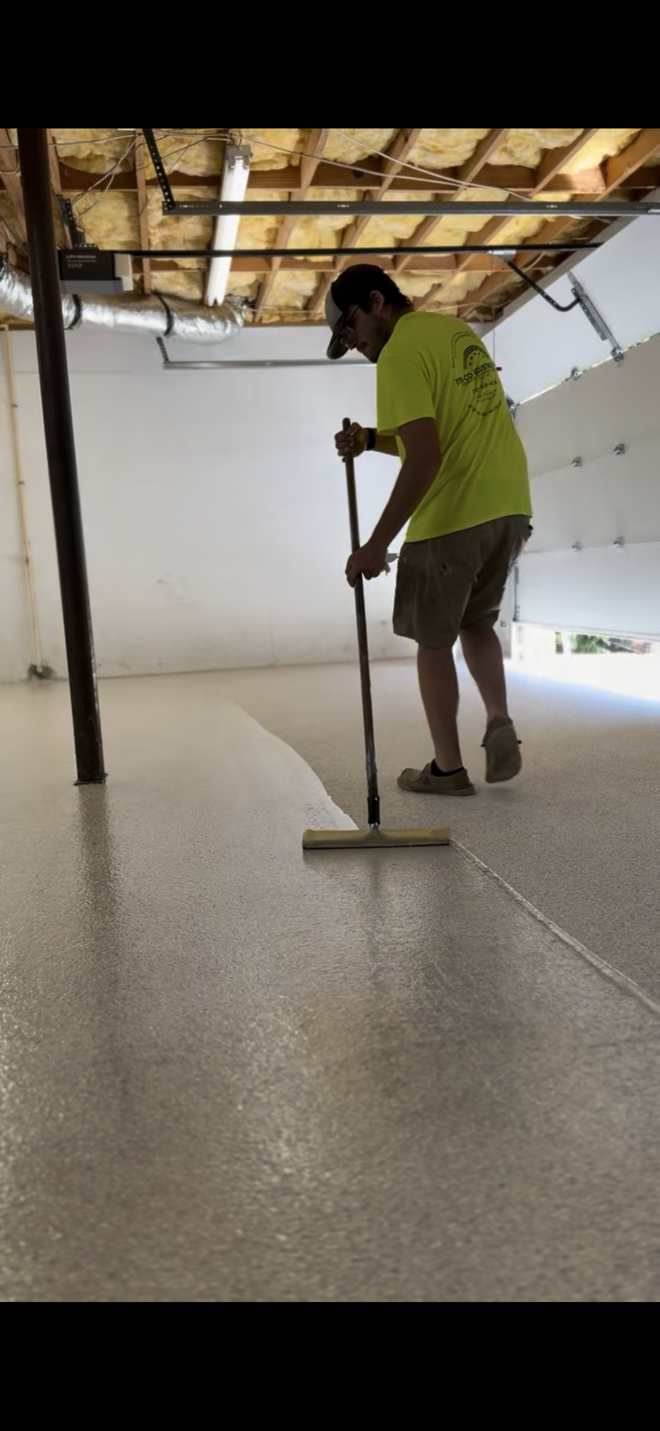 Applying a polyaspartic clear coat in a basement project located in Cornelia, Georgia