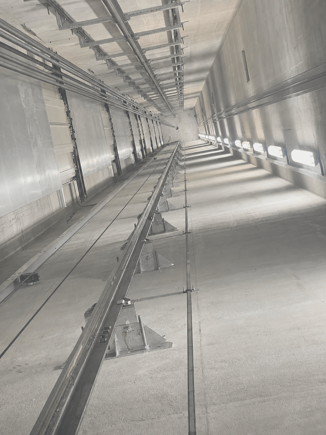 The guide brackets installed in a lift shaft, from the view of being on the car top.
