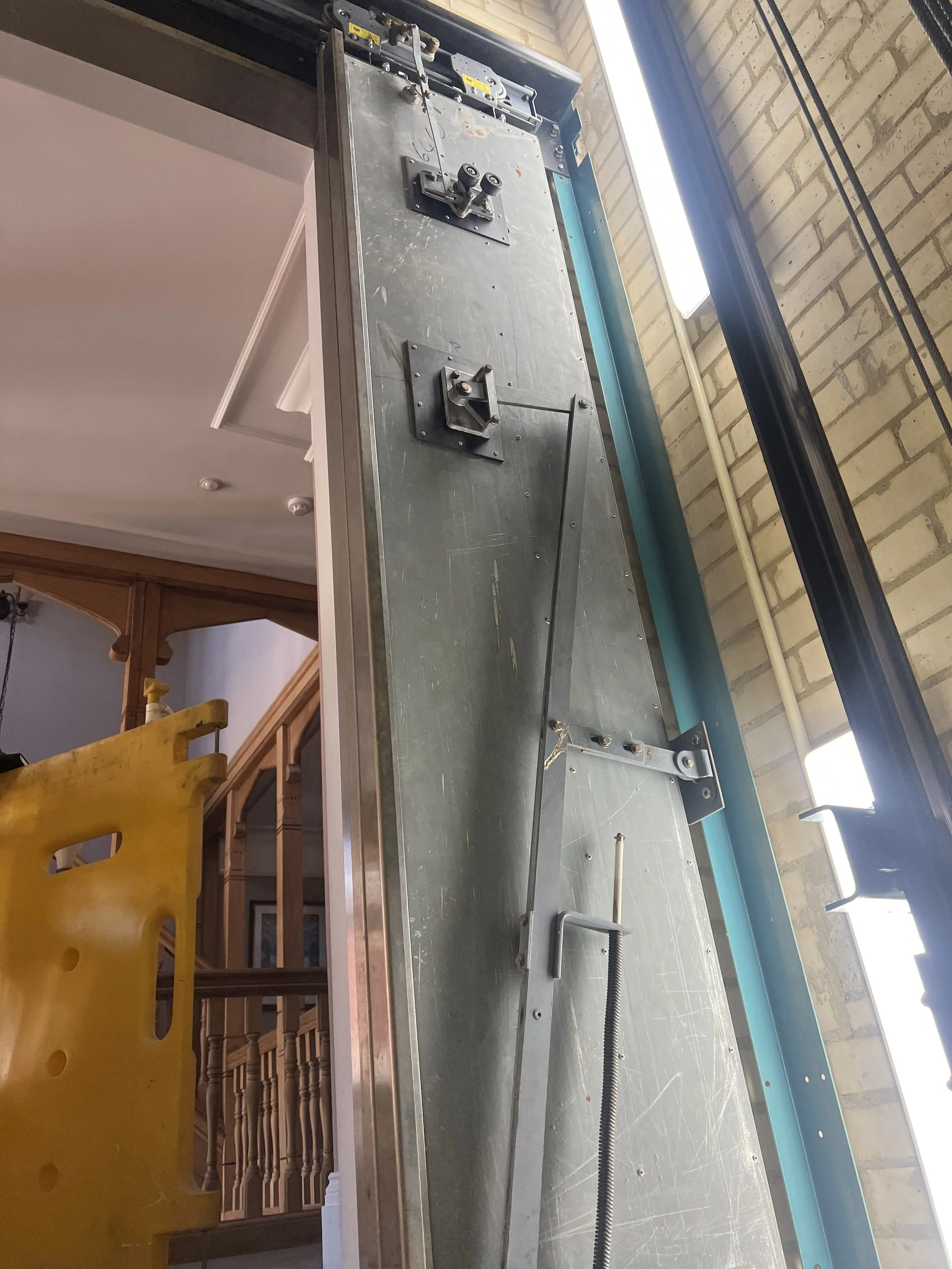 A 'GAL' Brand landing lift door, from the inside showing the rollers and assembely.