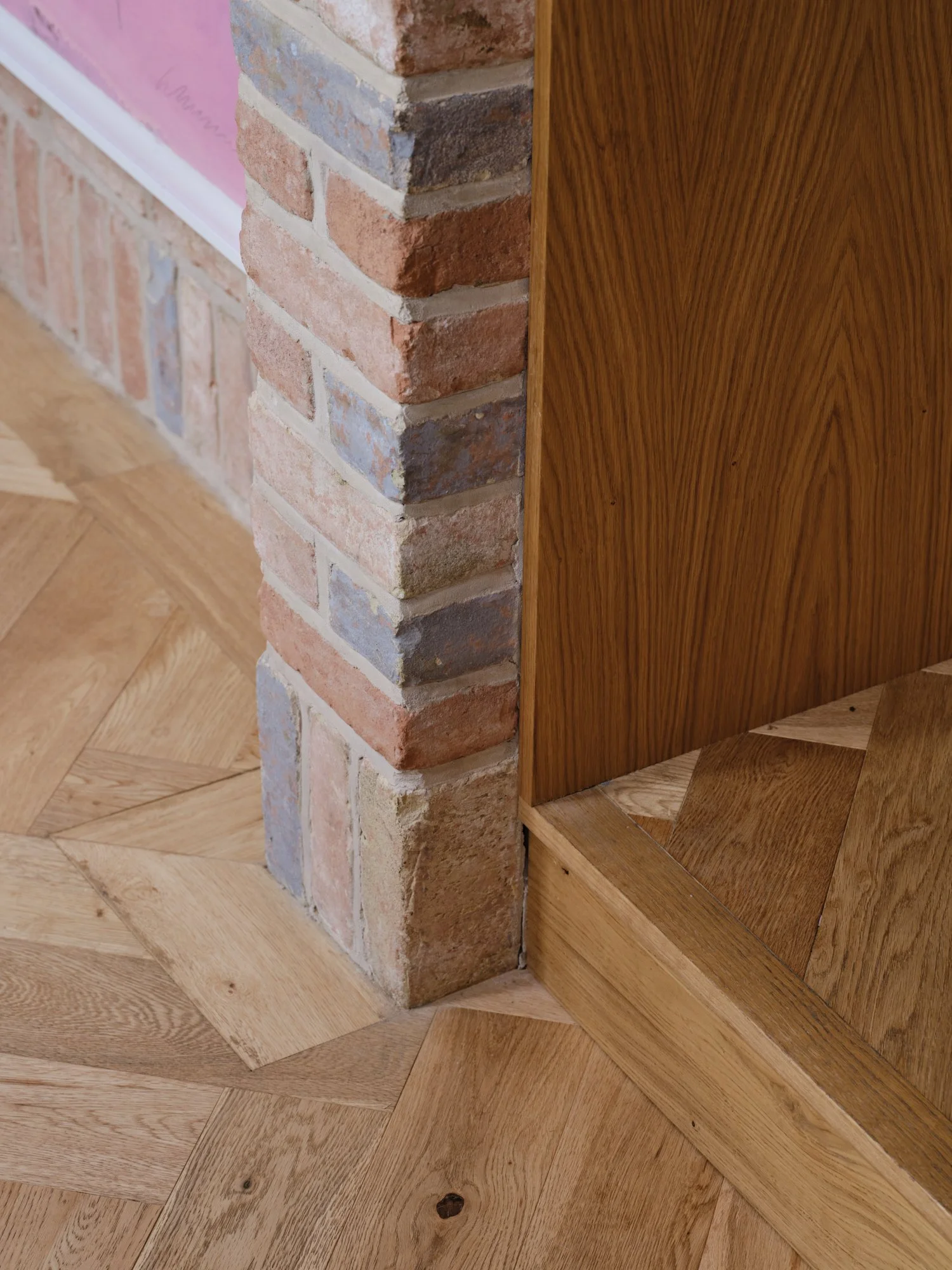 Exposed brick pier meeting oak joinery and herringbone flooring, Cromwell Road, Teddington